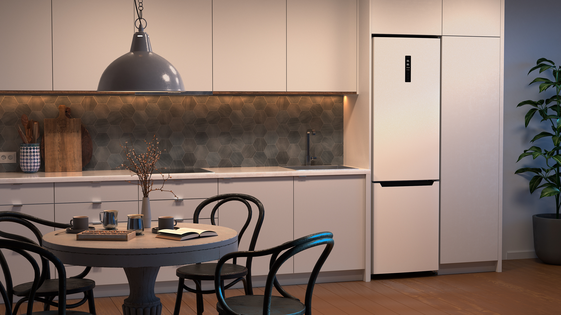 Cocina moderna con gabinetes blancos, mesa redonda y nevera grande.