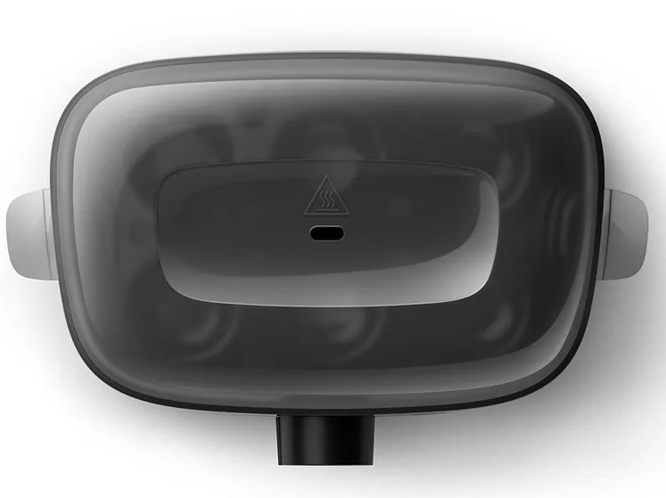 Czarny widok z góry urządzenia. Ma dwa białe uchwyty boczne i mały symbol ostrzegawczy o ciepło.