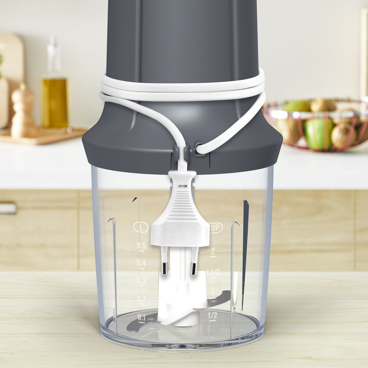 A blender with a plug and a white cord on a table.