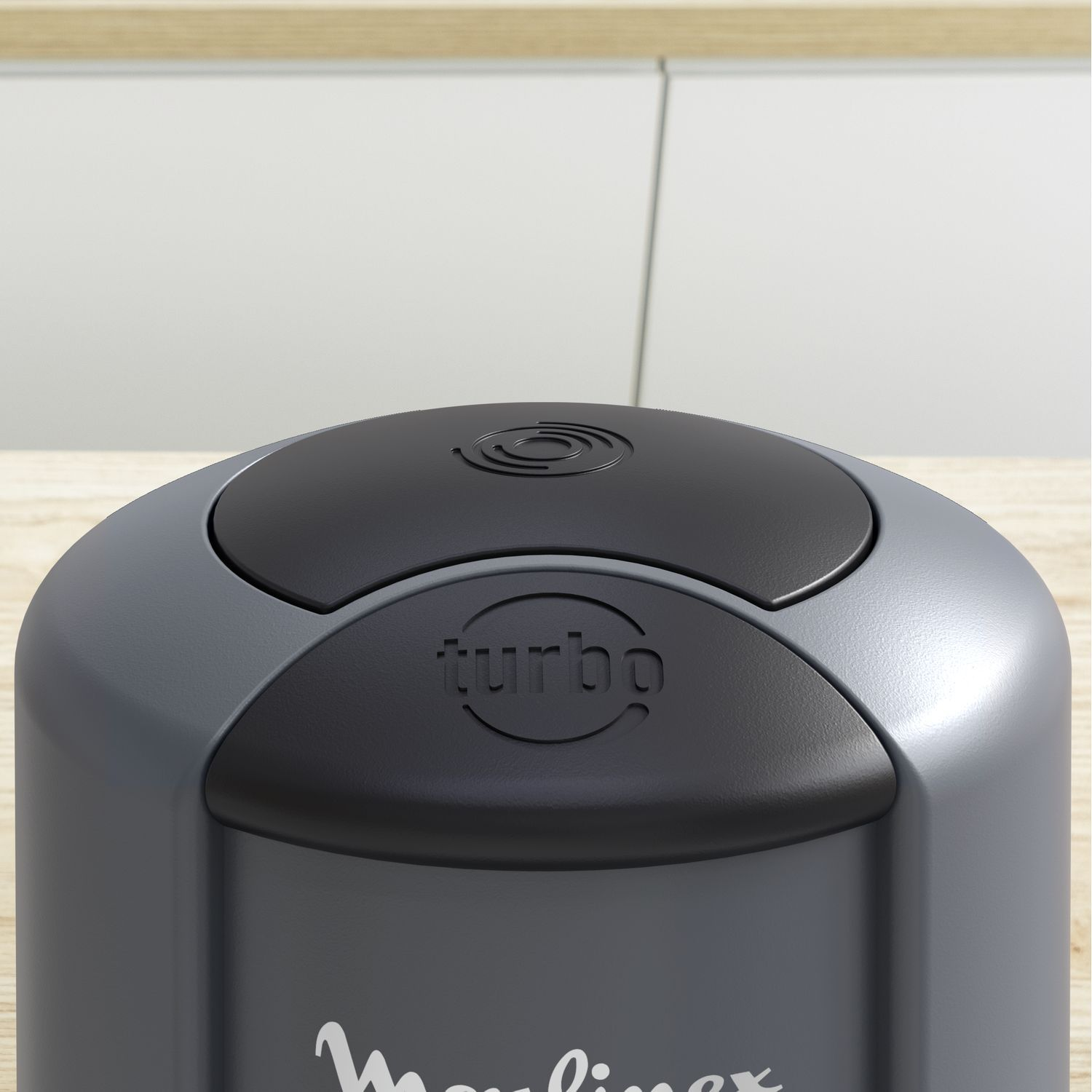 Gray and black food processor, top view, with the word turbo on it.
