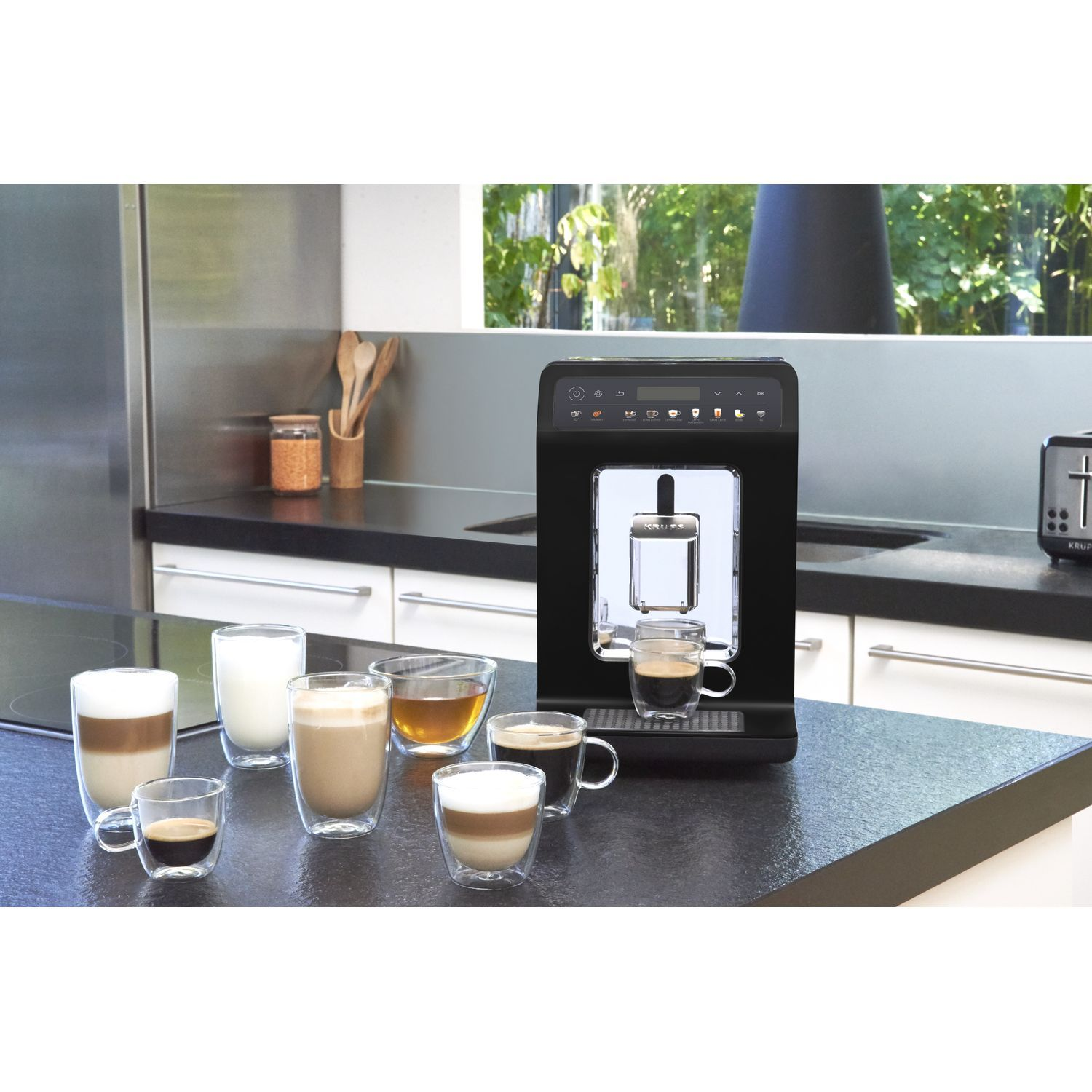 A black coffee machine with multiple glasses of coffee drinks on a black countertop.