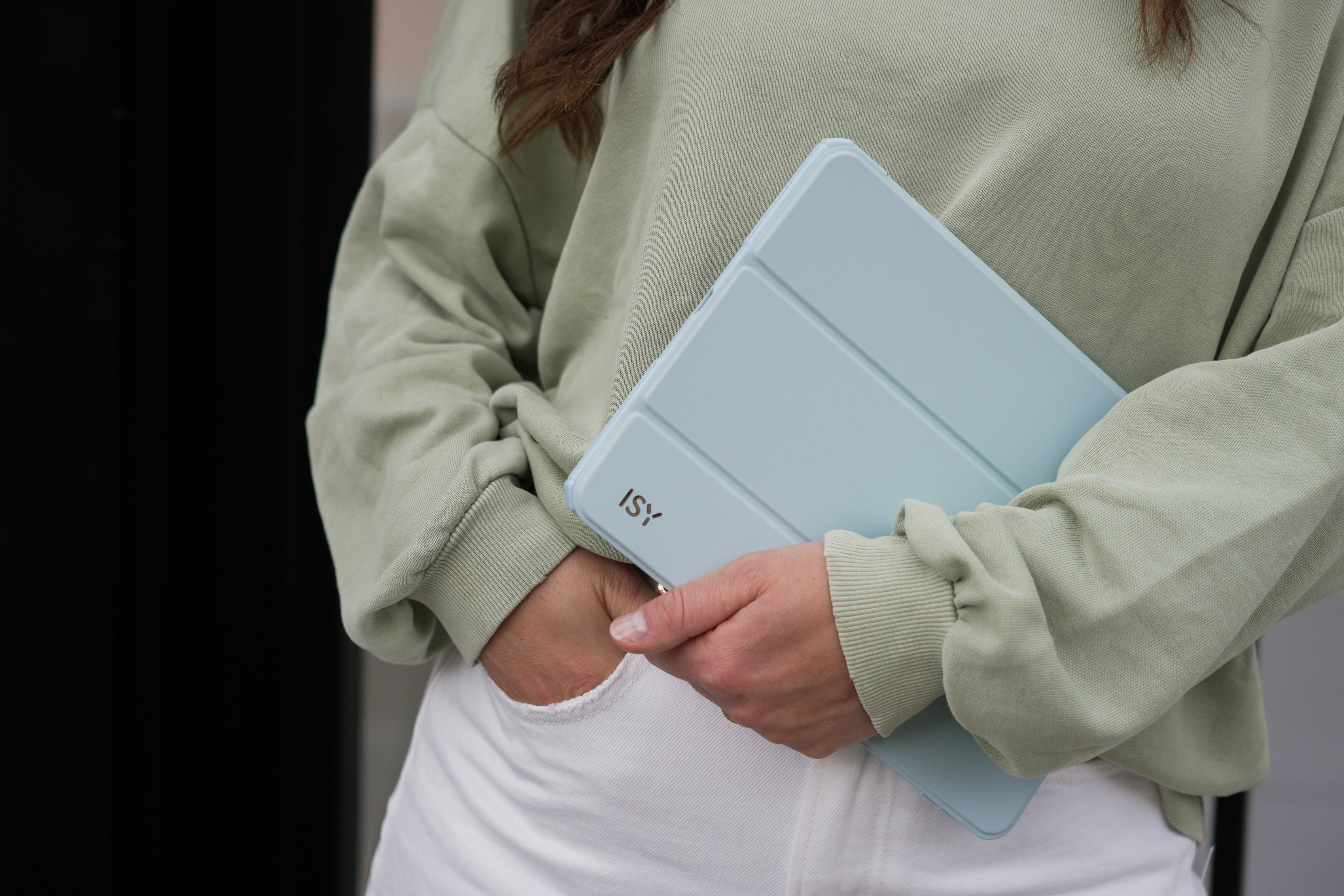 Person hält eine hellblaue Tablet-Hülle mit dem ISY-Logo.