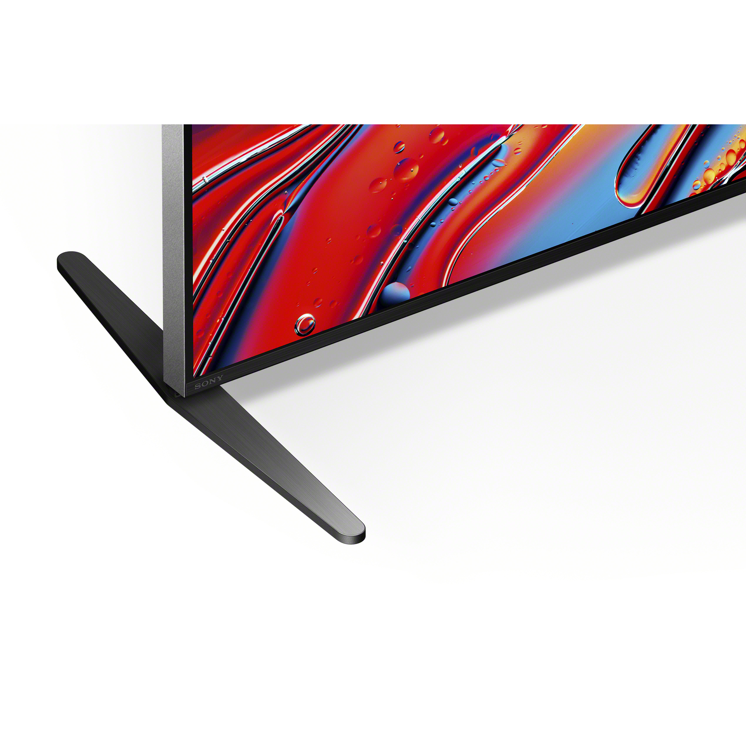 Gros plan d'un téléviseur avec une base noire et un écran coloré.