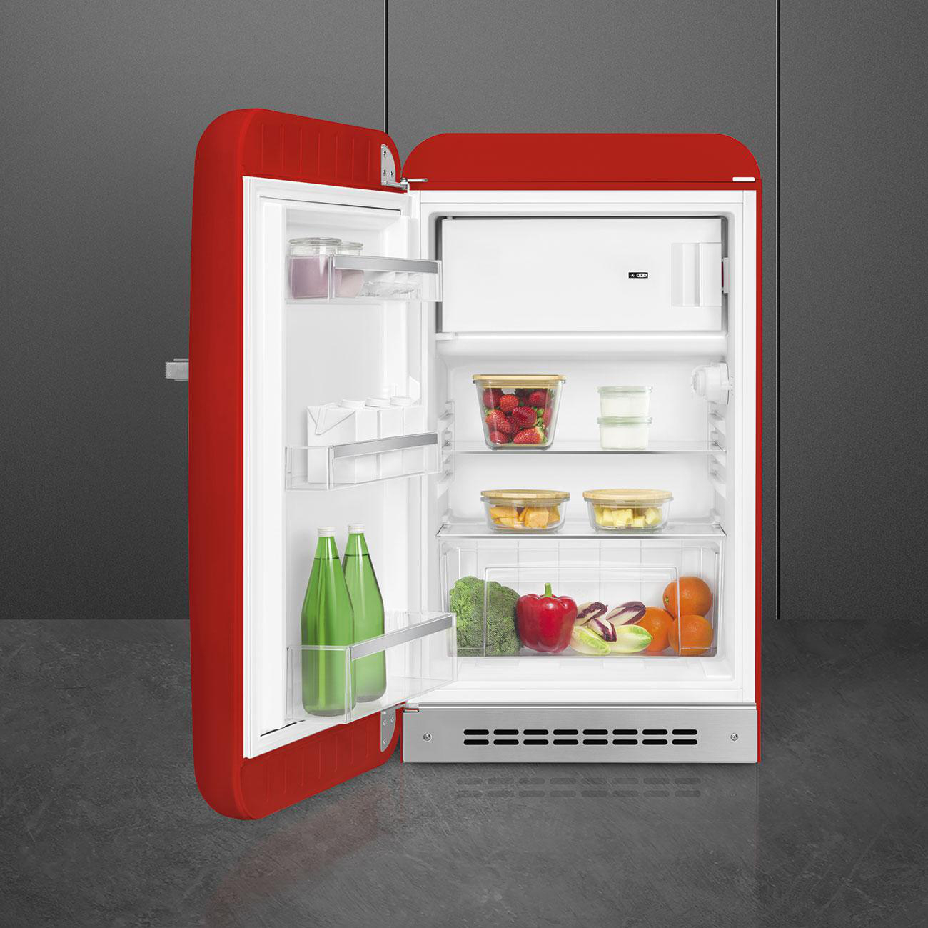 Ein roter Kühlschrank mit offener Tür, der Regale mit Lebensmitteln und Getränken zeigt. Es hat ein weißes Innere.