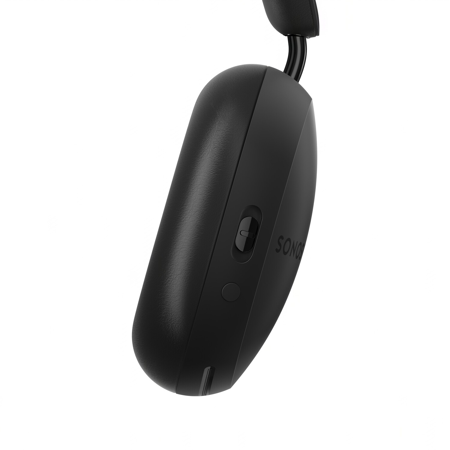 Close-up of a black headphone. The right ear cup is shown with a button.