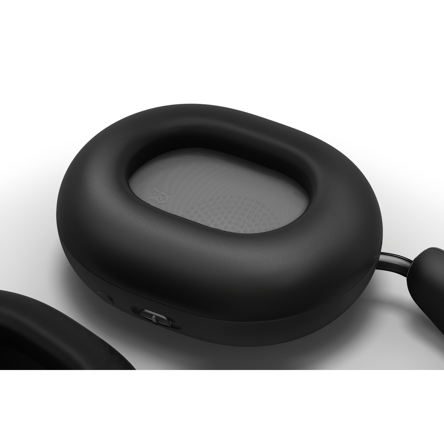 Close-up of black headphones with a cushioned ear cup. The focus is on the ear cup's soft material and shape.