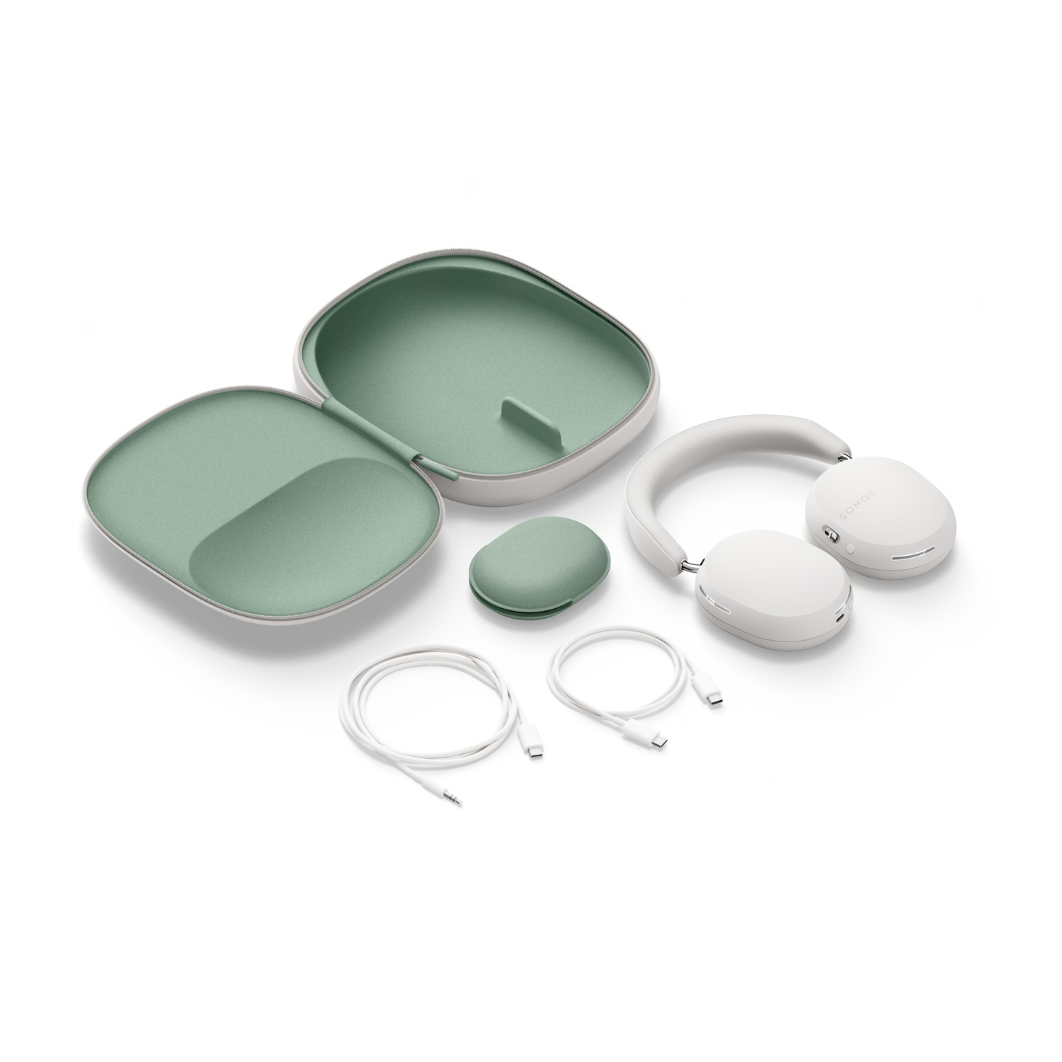 White headphones, case, and accessories on white. Headphones are open. Case is green inside.