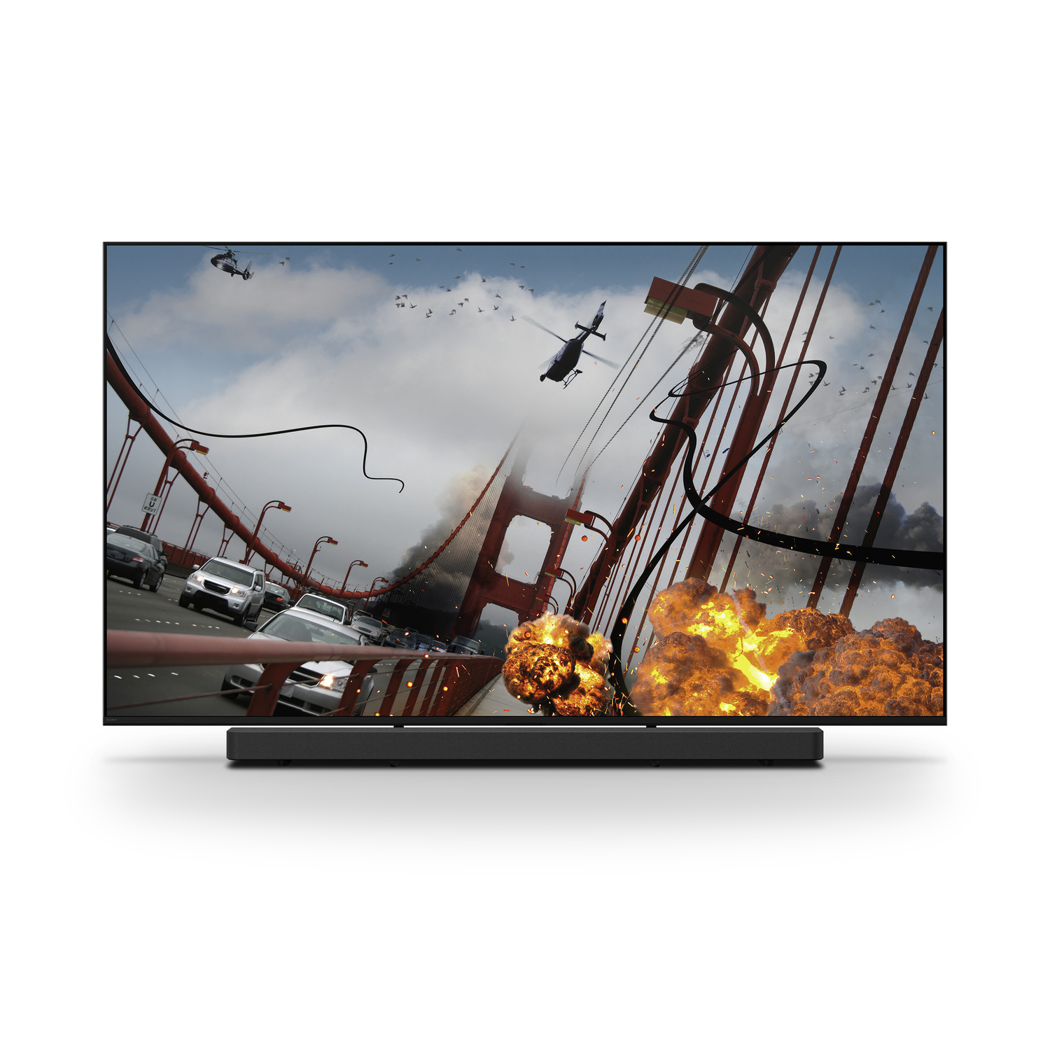 Une télévision affiche des explosions sur un pont, une barre de son noire est en dessous. Un hélicoptère vole.