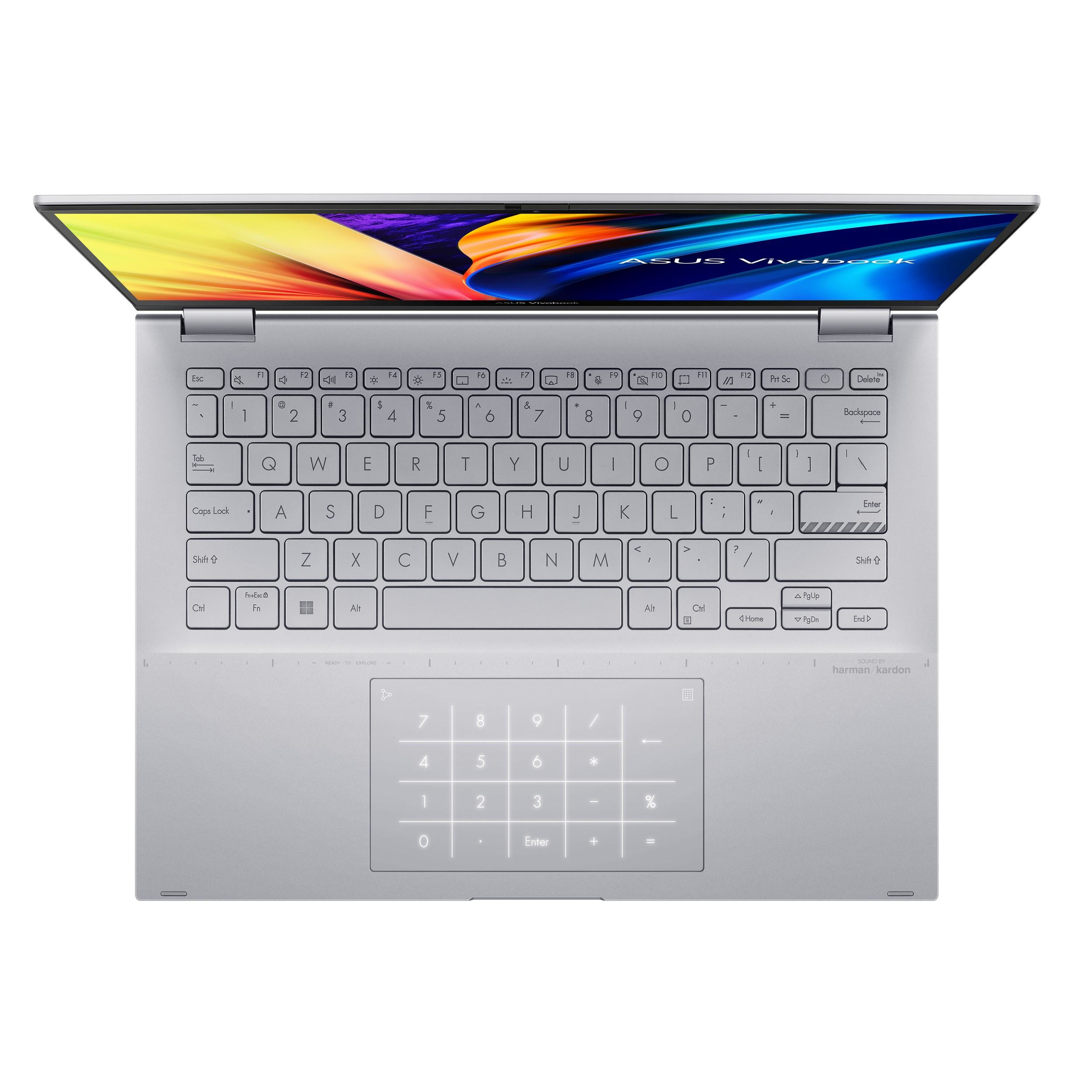 Ordenador portátil plateado, abierto, teclado visible, panel táctil con teclado numérico, pantalla con imagen colorida.