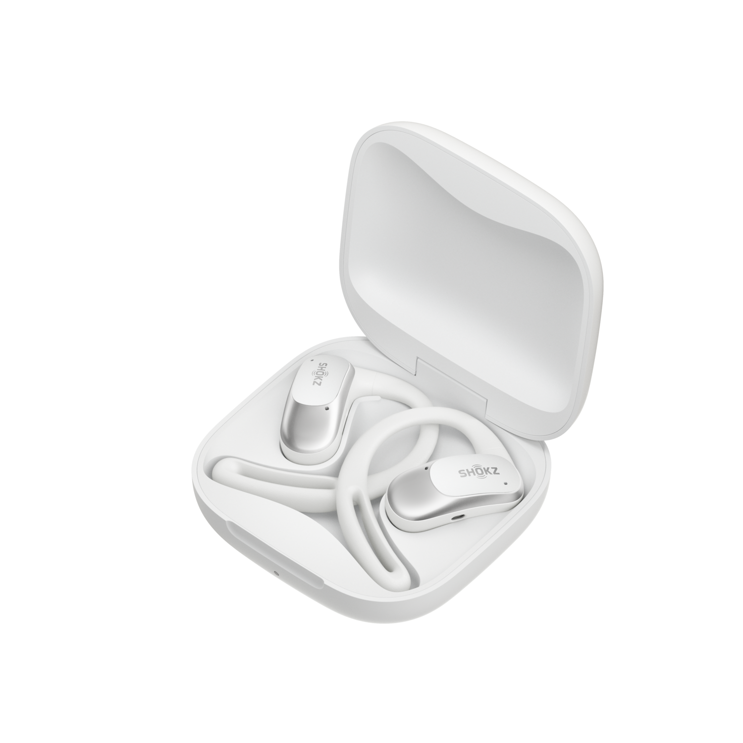 White Shokz headphones and charging case are open on a black background.