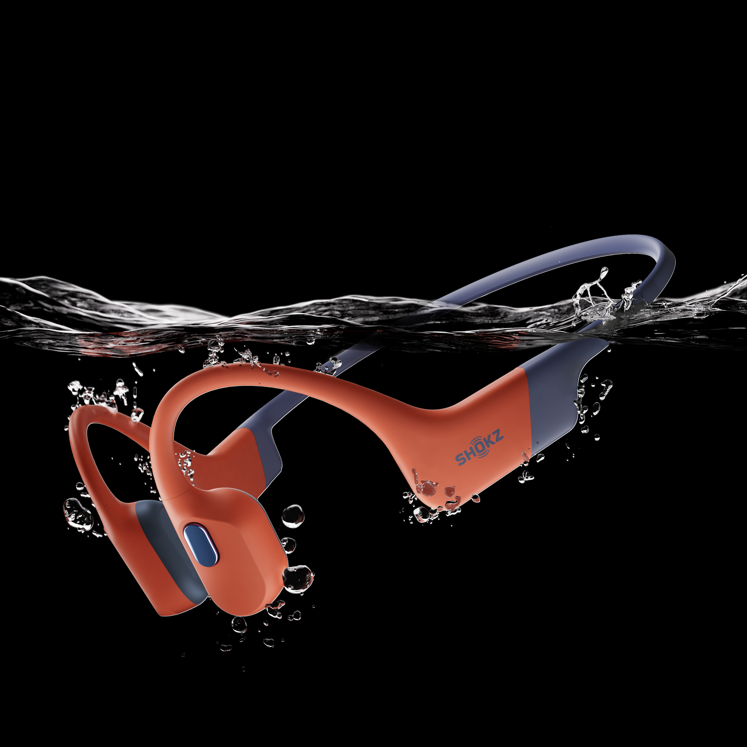 Orange and blue Shokz headphones submerged in water.