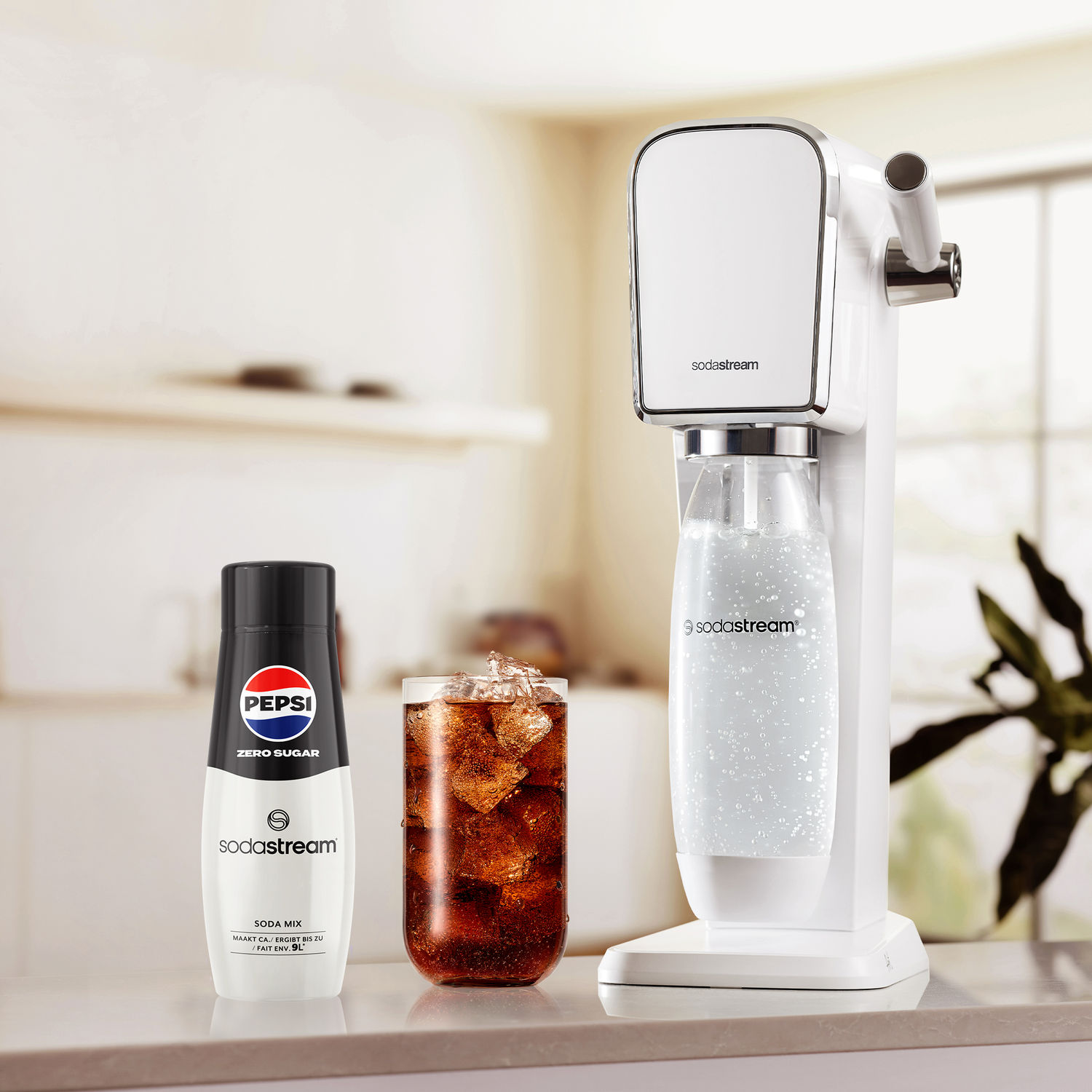 SodaStream machine, Pepsi Zero Sugar mix, and a glass of cola with ice on a kitchen counter.