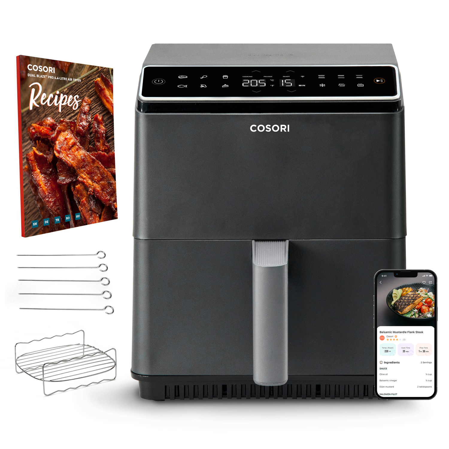 Zwarte airfryer met accessoires en een receptenboek. Een smartphone toont een recept.