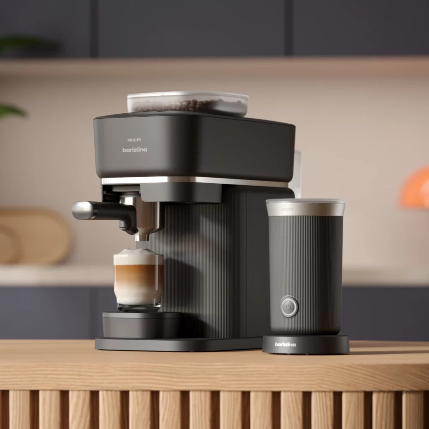 Black coffee machine with a glass of coffee and a milk frother on a wooden surface.