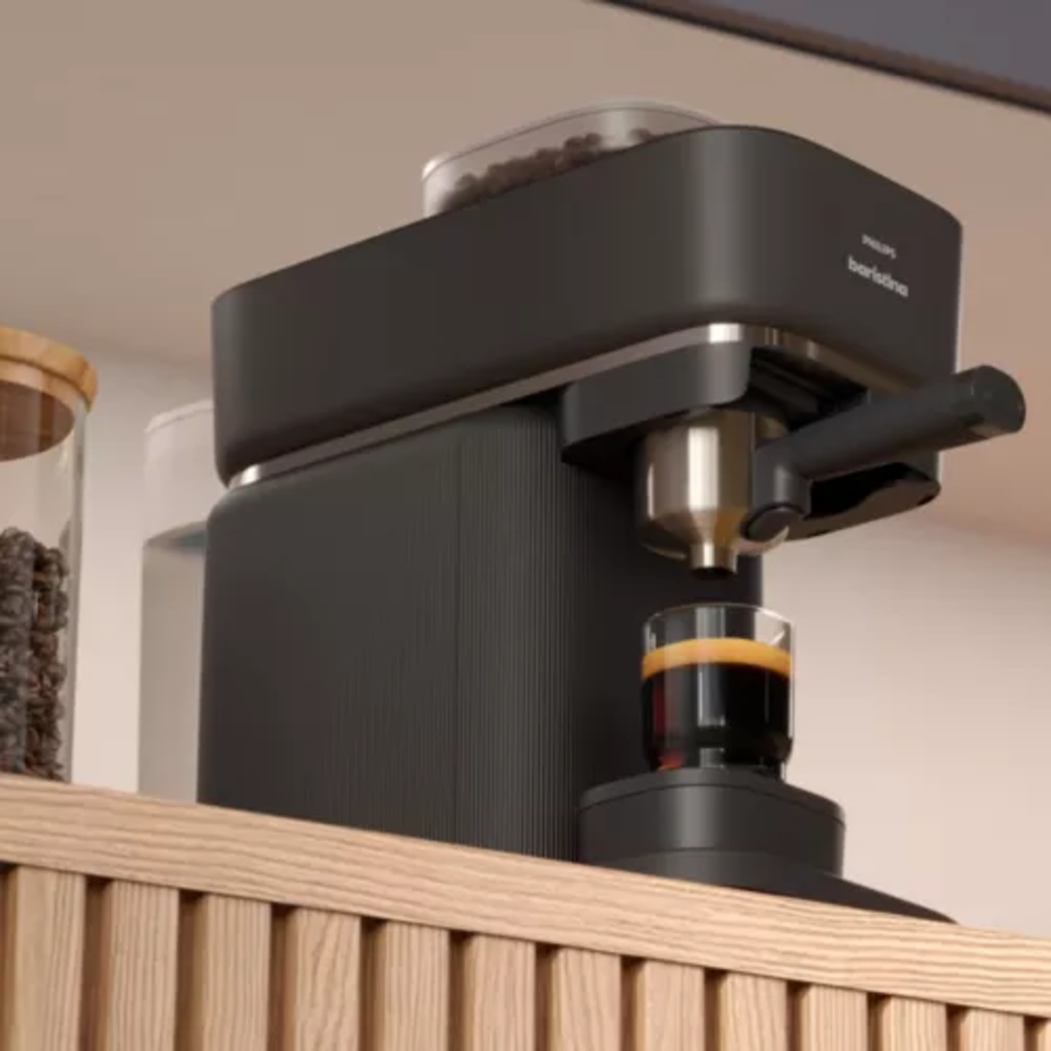 Black Philips Barista espresso machine on a wooden shelf, with a glass of coffee.