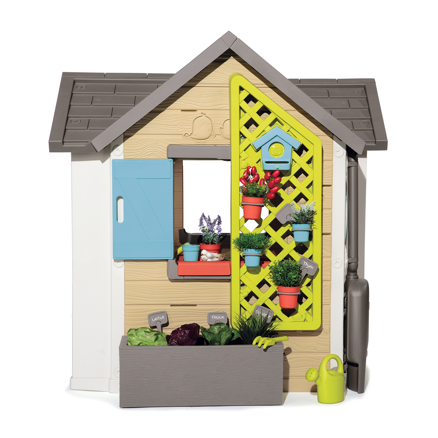 Una casetta per bambini con un traliccio verde e un piccolo giardino con piante.
