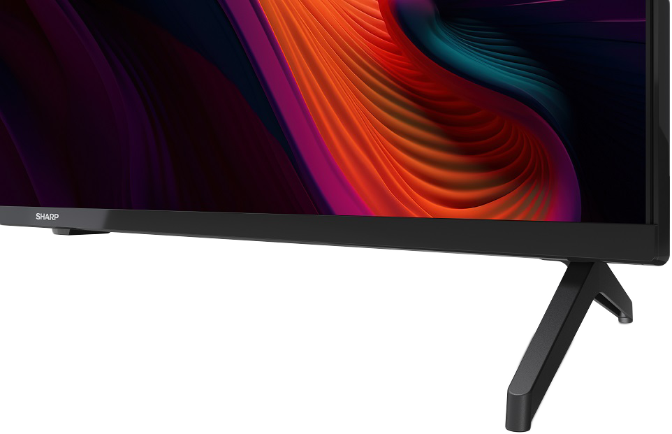 Közelkép egy fekete TV talpáról és állványáról. Sharp logó látható.