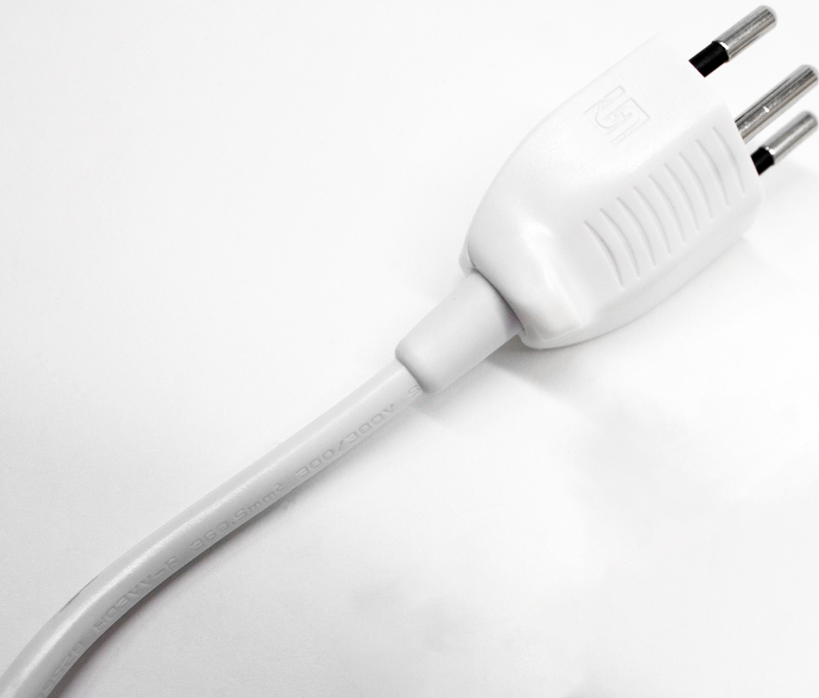 Prise électrique blanche avec trois broches sur fond blanc, avec le cordon s'étendant vers le bas.
