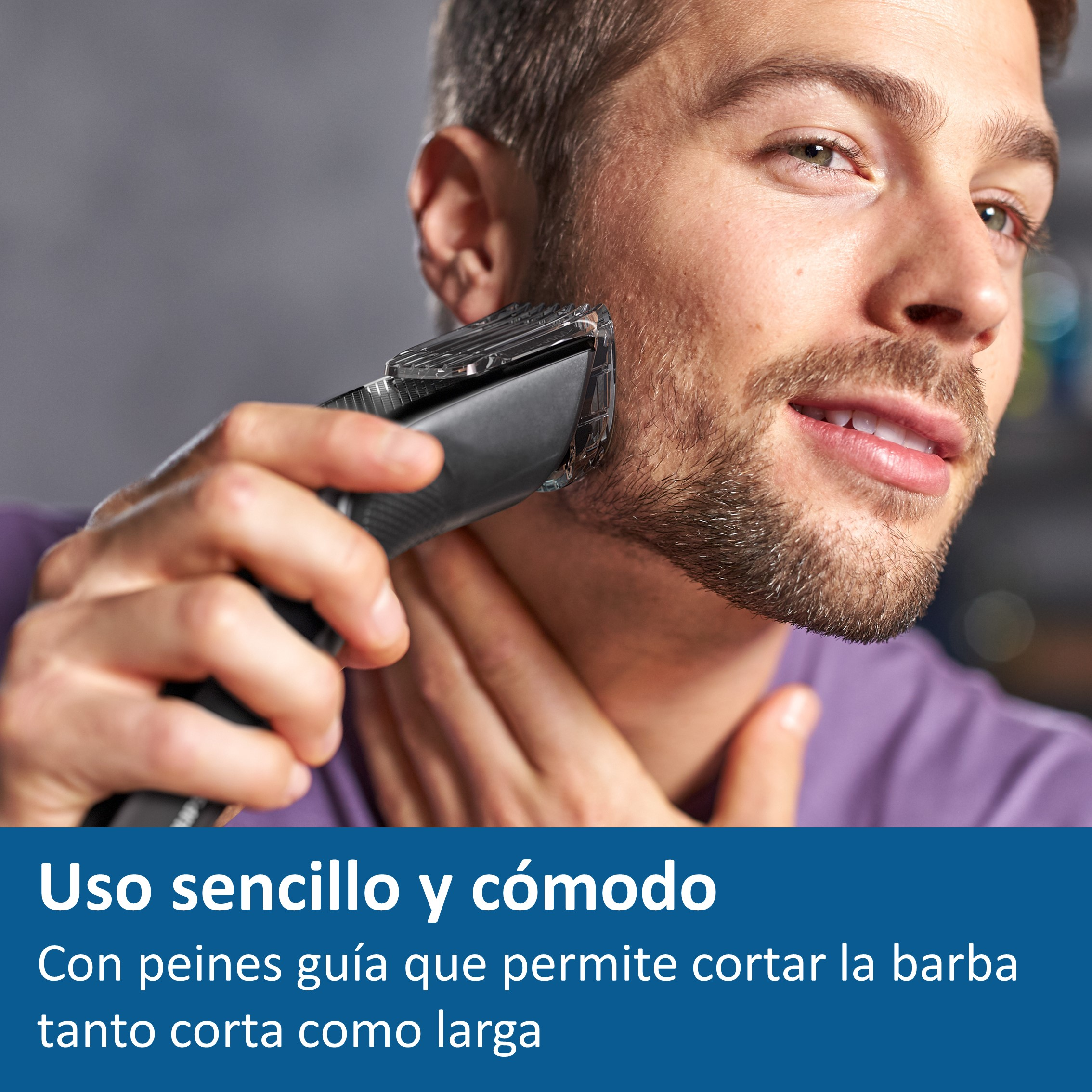 Hombre se afeita la barba con una recortadora negra. La recortadora corta cerca de la piel.