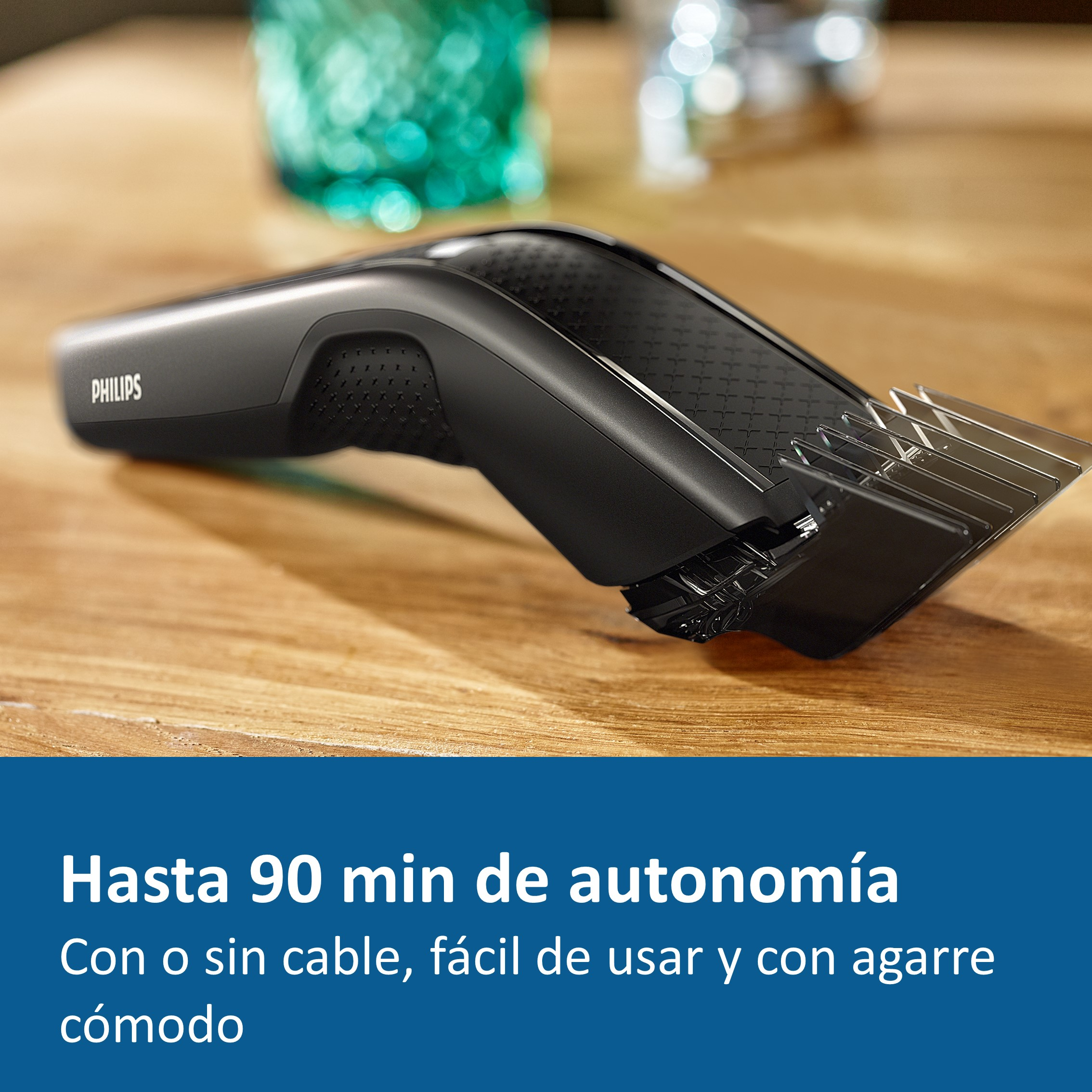 Una cortadora de pelo Philips negra sobre una mesa de madera. El texto dice: Hasta 90 min de autonomía.