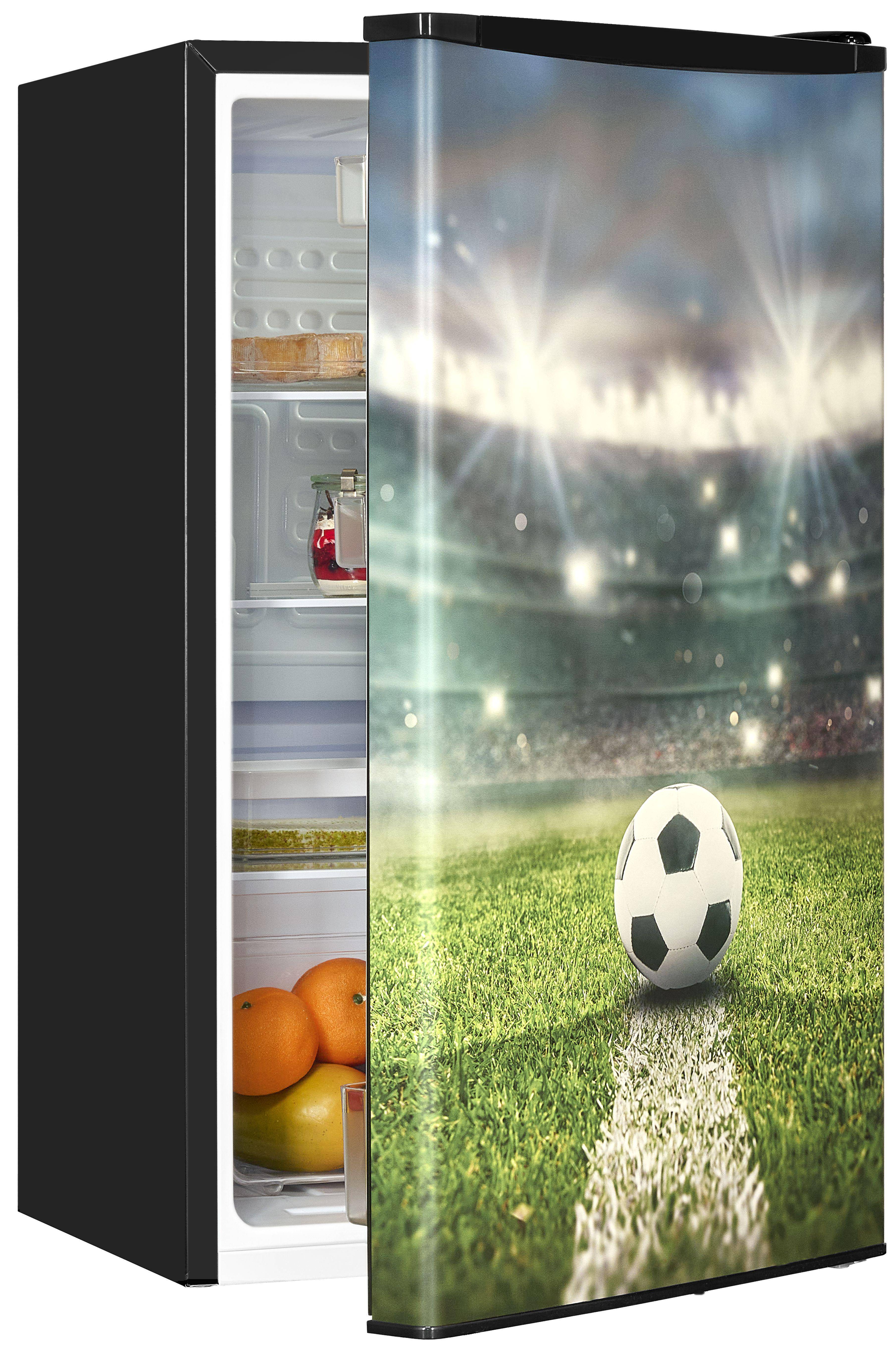 Schwarzer Kühlschrank mit Fußballstadion-Grafik auf der Tür. Innen: Orangen und Lebensmittel.