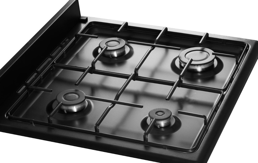 Black gas stove top with four burners and a metal grate. The burners are circular.