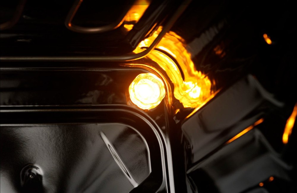Close-up of an oven interior. Yellow light illuminating the oven's interior.