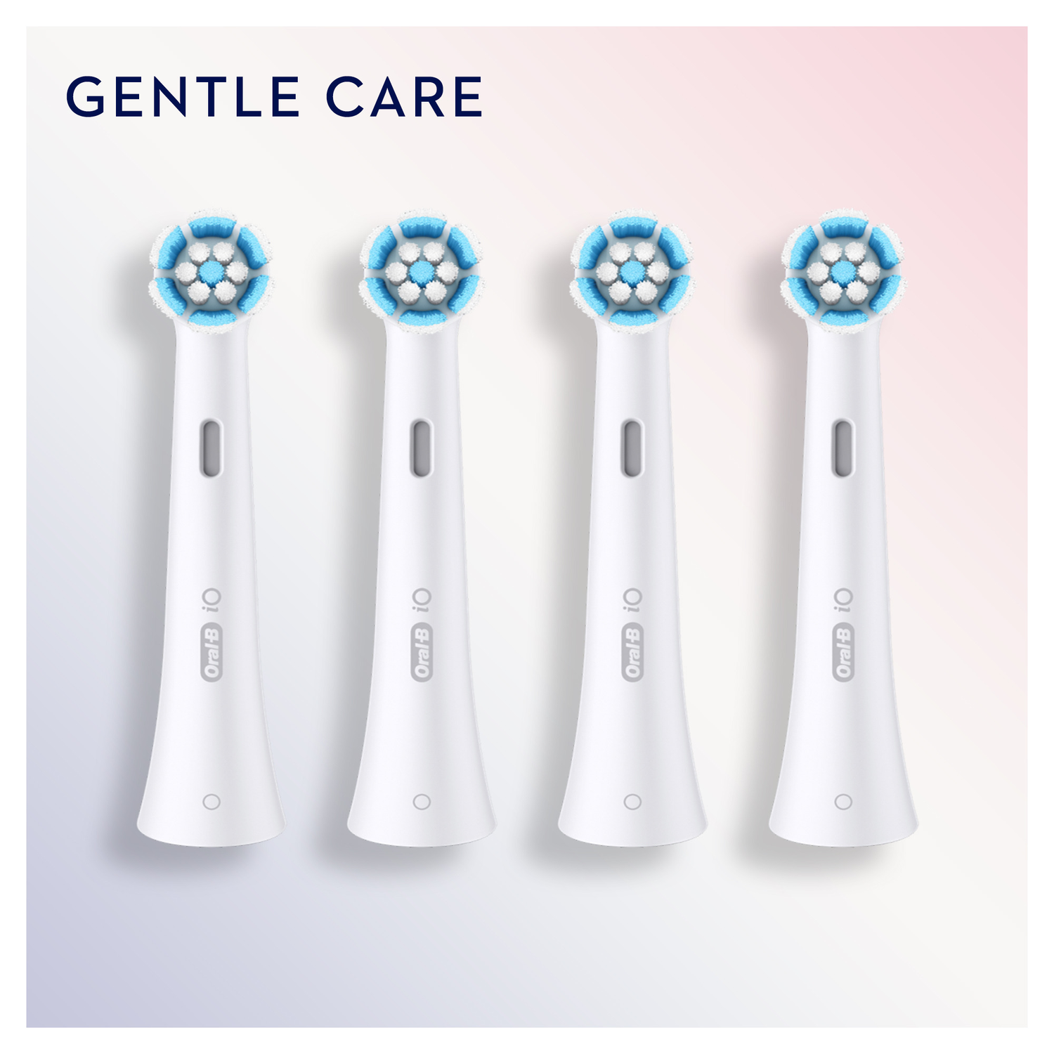 Four white toothbrush heads with blue bristles against a light pink background.