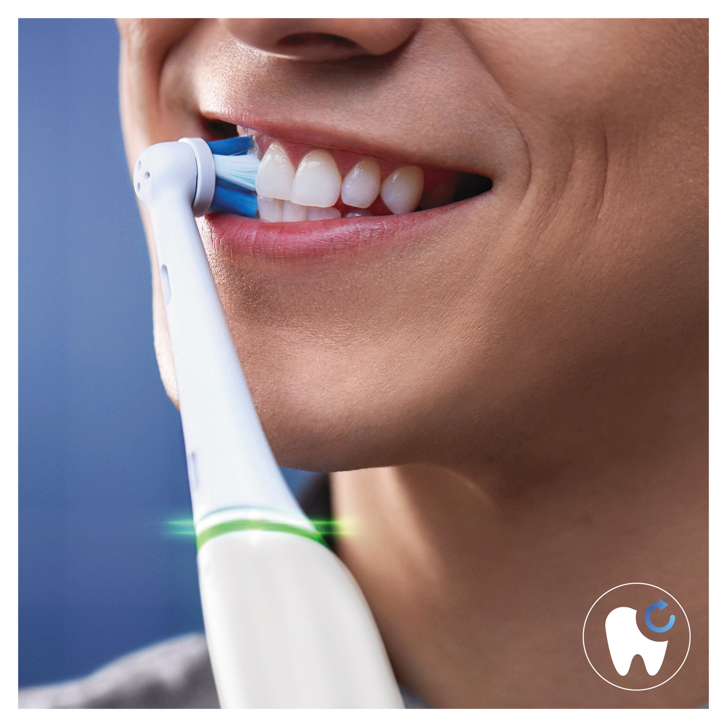 A person brushing their teeth with a white electric toothbrush, showing the teeth and brush head.