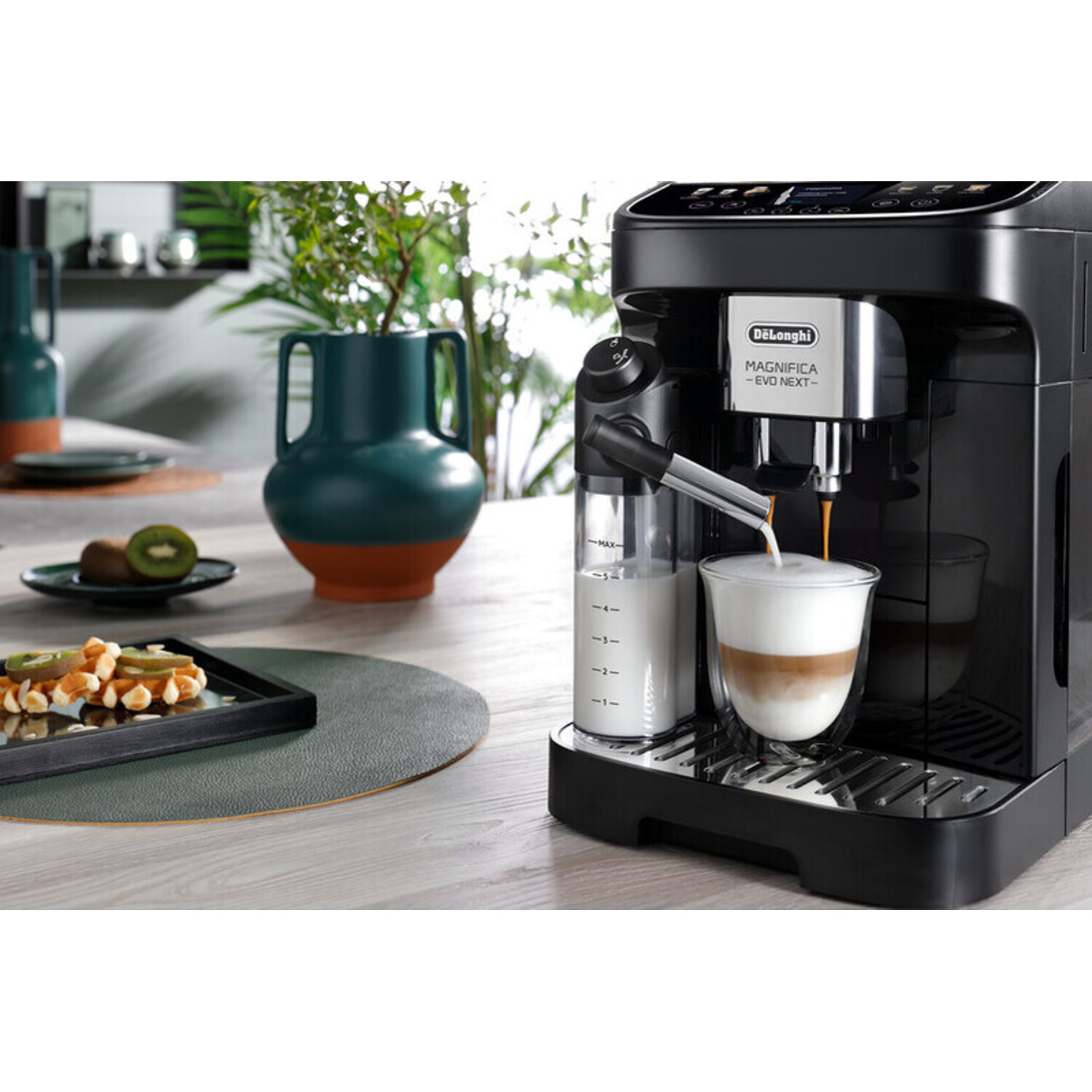 Black espresso machine pouring coffee into a glass cup on a wooden table, with kiwi and vase.