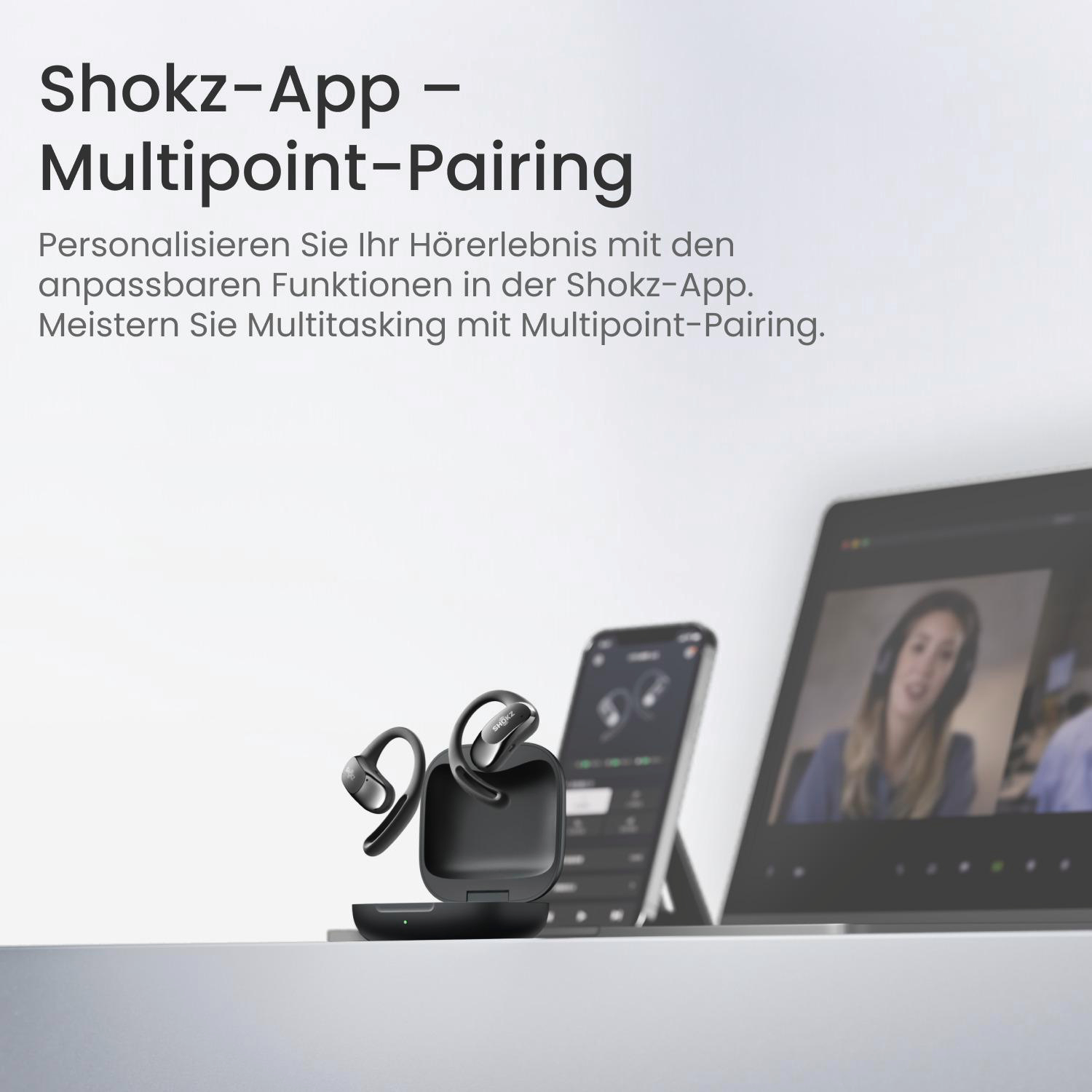 Schwarze Shokz-Ohrhörer in einem Ladecase, mit einem Telefon und Laptop, der die App-Oberfläche anzeigt, und eine Frau im Videoanruf.