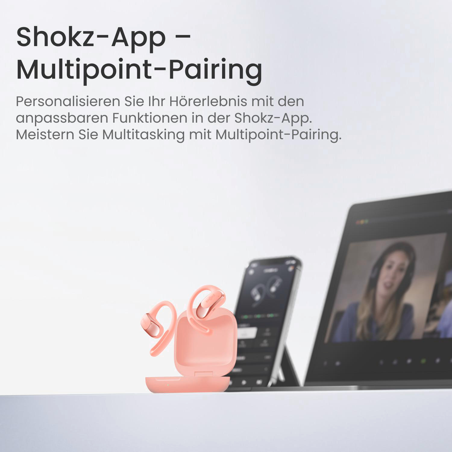 Rosa Shokz-Kopfhörer und -Etui, ein Telefon und ein Laptop mit einem Videoanruf. Text: Shokz-App - Multipoint-Pairing.