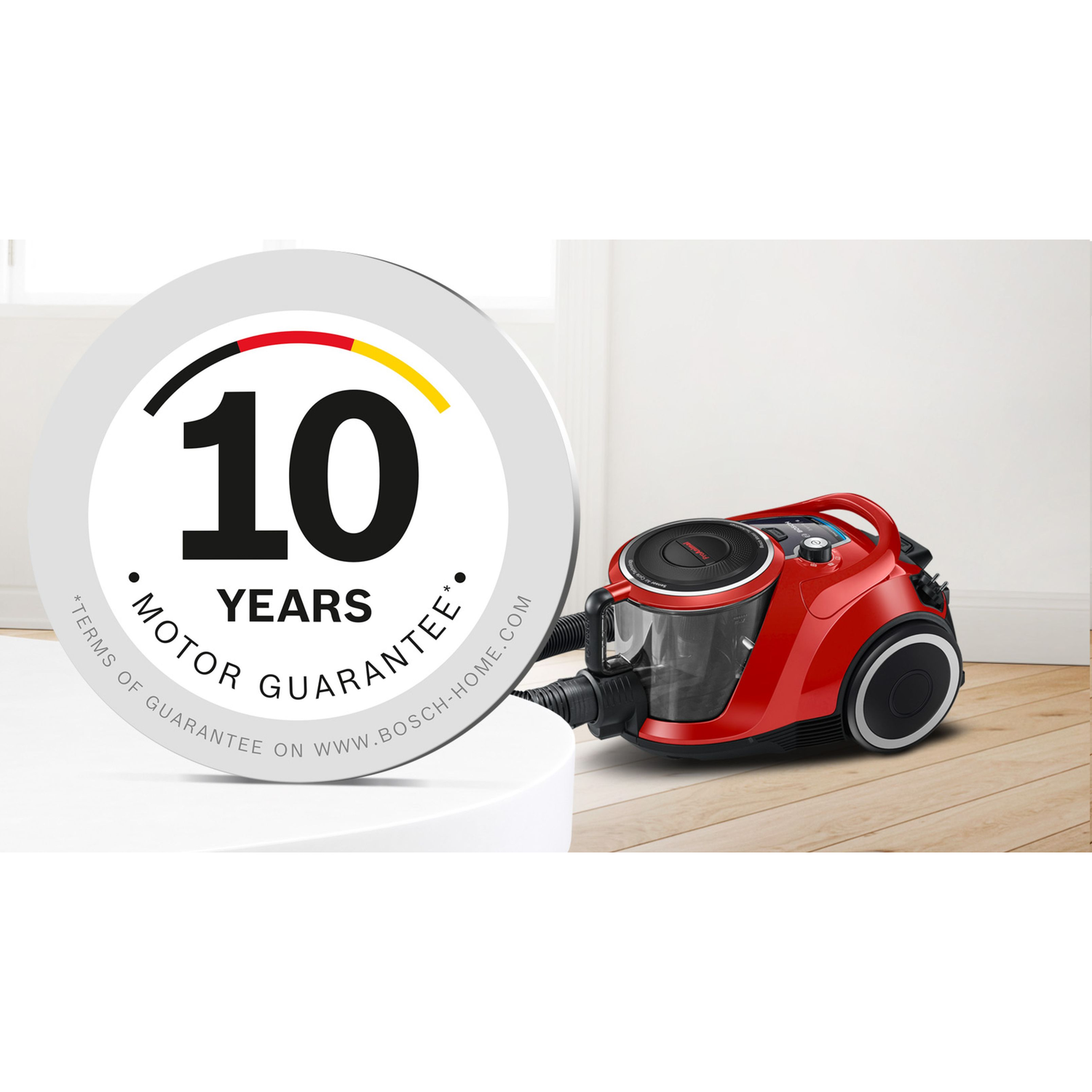 Red vacuum cleaner with a '10 years motor guarantee' sticker.