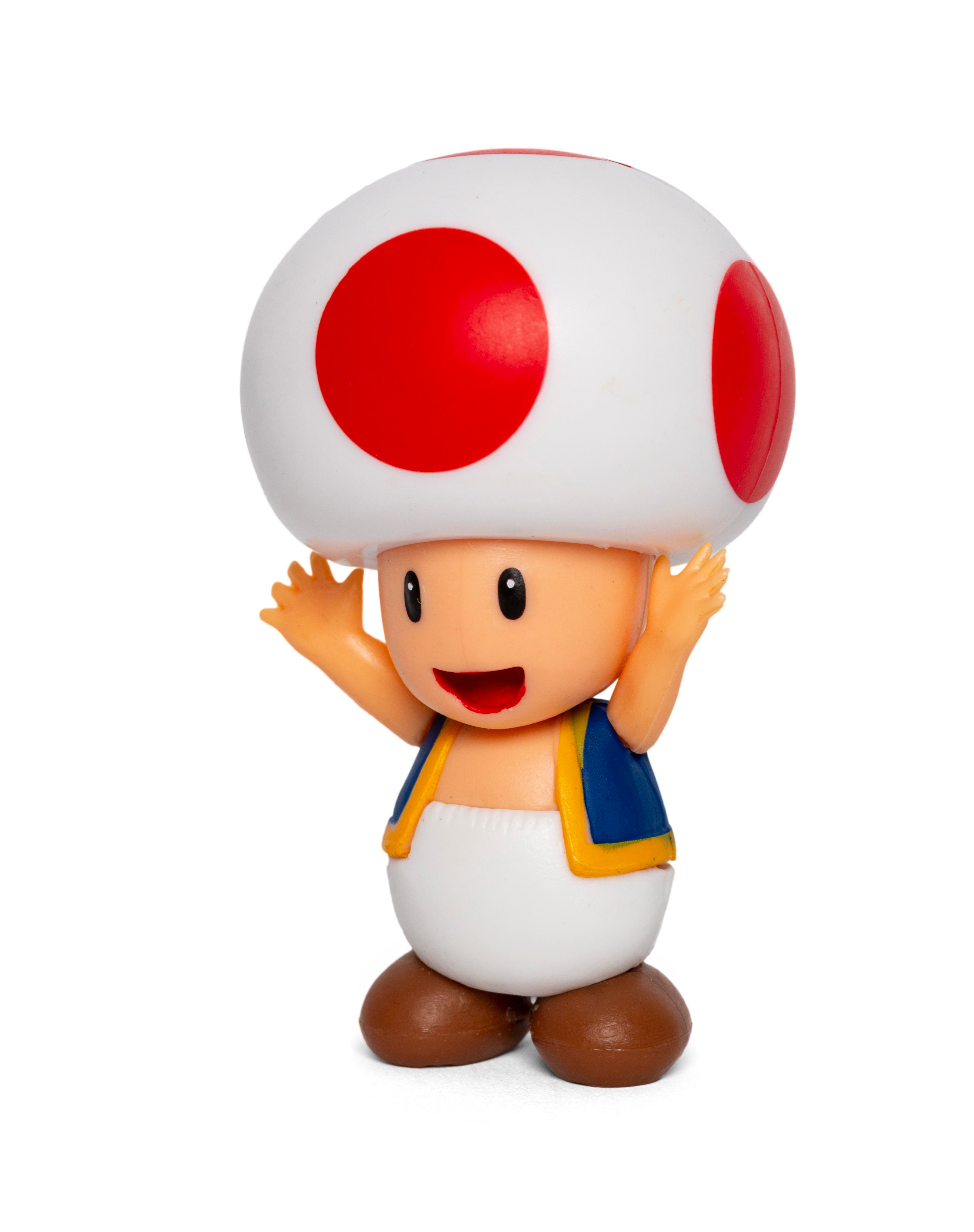 Toad-Figur, rot gefleckter Pilzkopf, orangefarbenes Gesicht, Arme erhoben, blaue Weste.