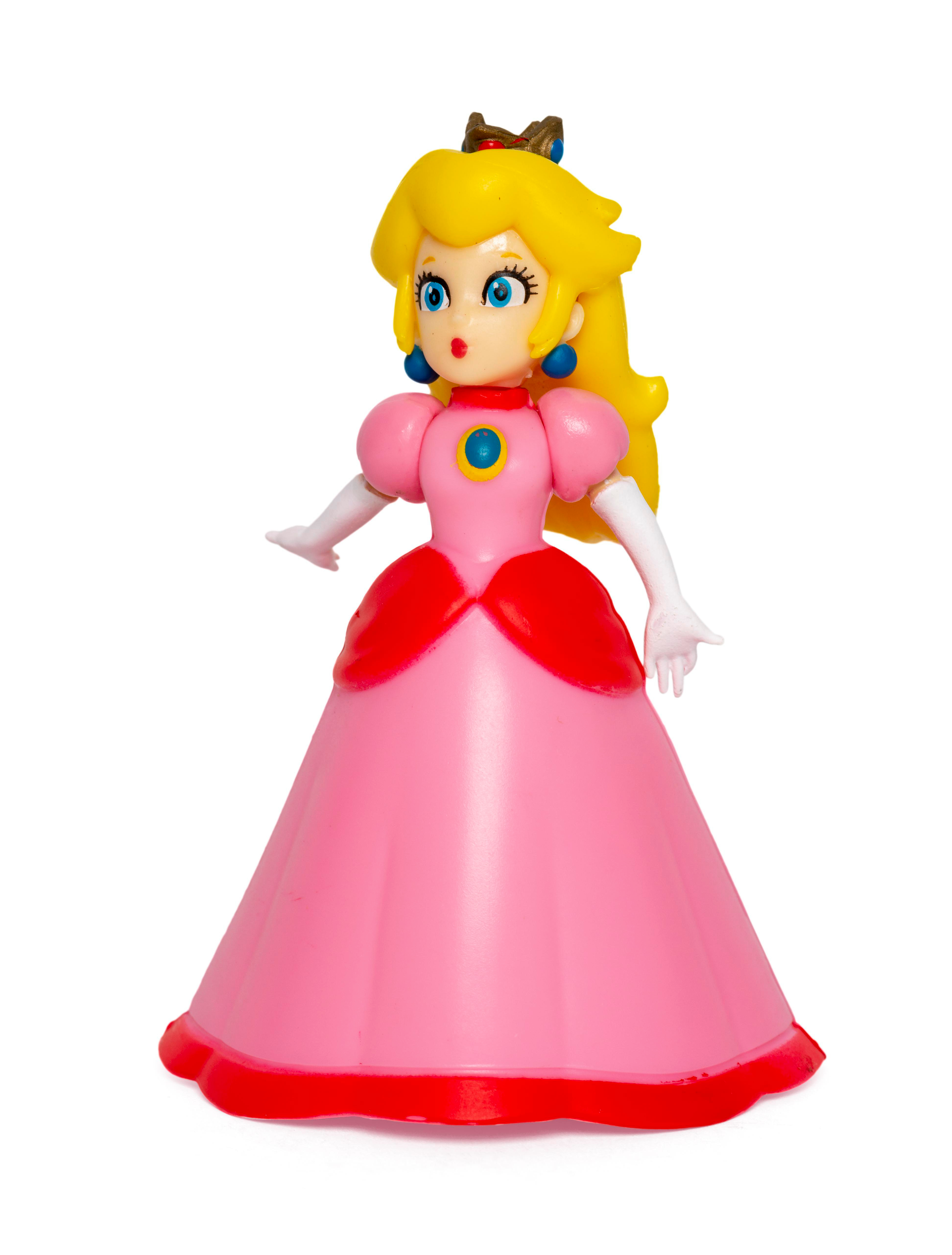 Eine Prinzessin Peach-Figur in einem rosa Kleid, weißen Handschuhen und einer Krone.