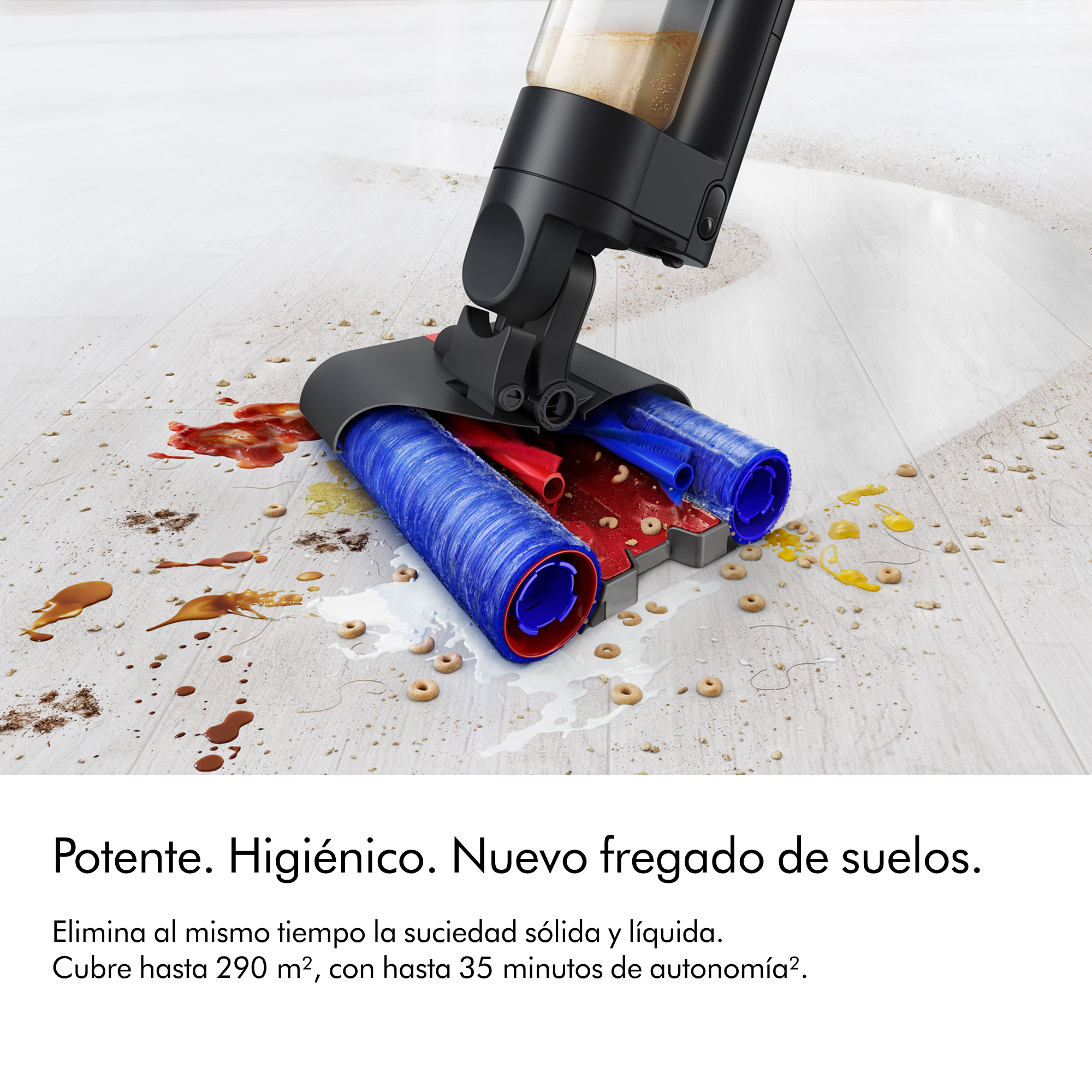 Una máquina de limpieza de pisos con un rodillo azul y rojo limpia un piso. Hay derrames de líquido.
