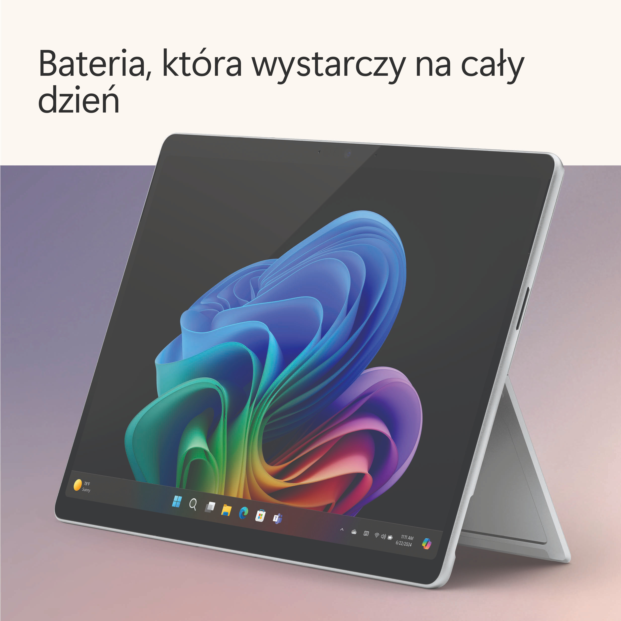 Laptop z kolorowym, abstrakcyjnym tłem. Tekst: 'Bateria, która wystarcza na cały dzień'.