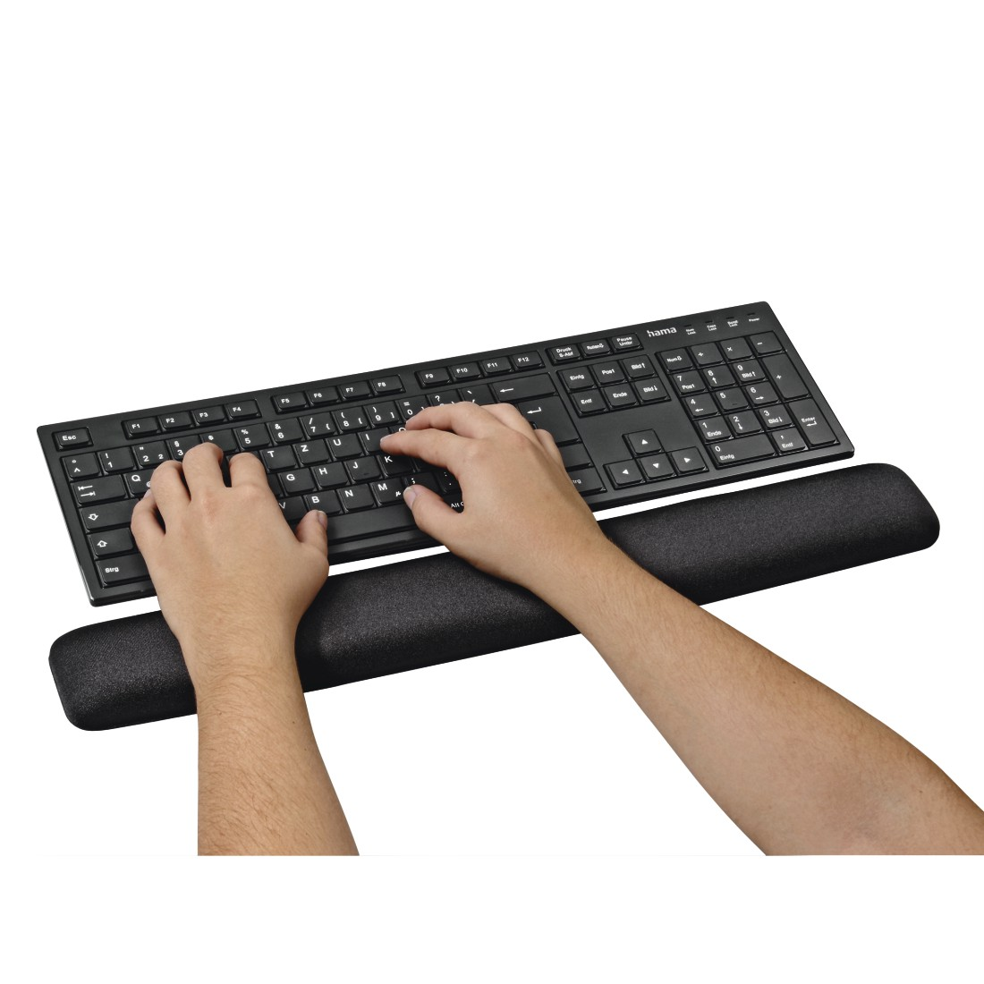 Manos escribiendo en un teclado negro con soporte de muñeca sobre fondo blanco.
