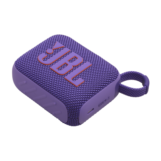 Mor JBL Go 3 hoparlör. Turuncu JBL logosu, düğmeler ve halka, siyah arka plan.