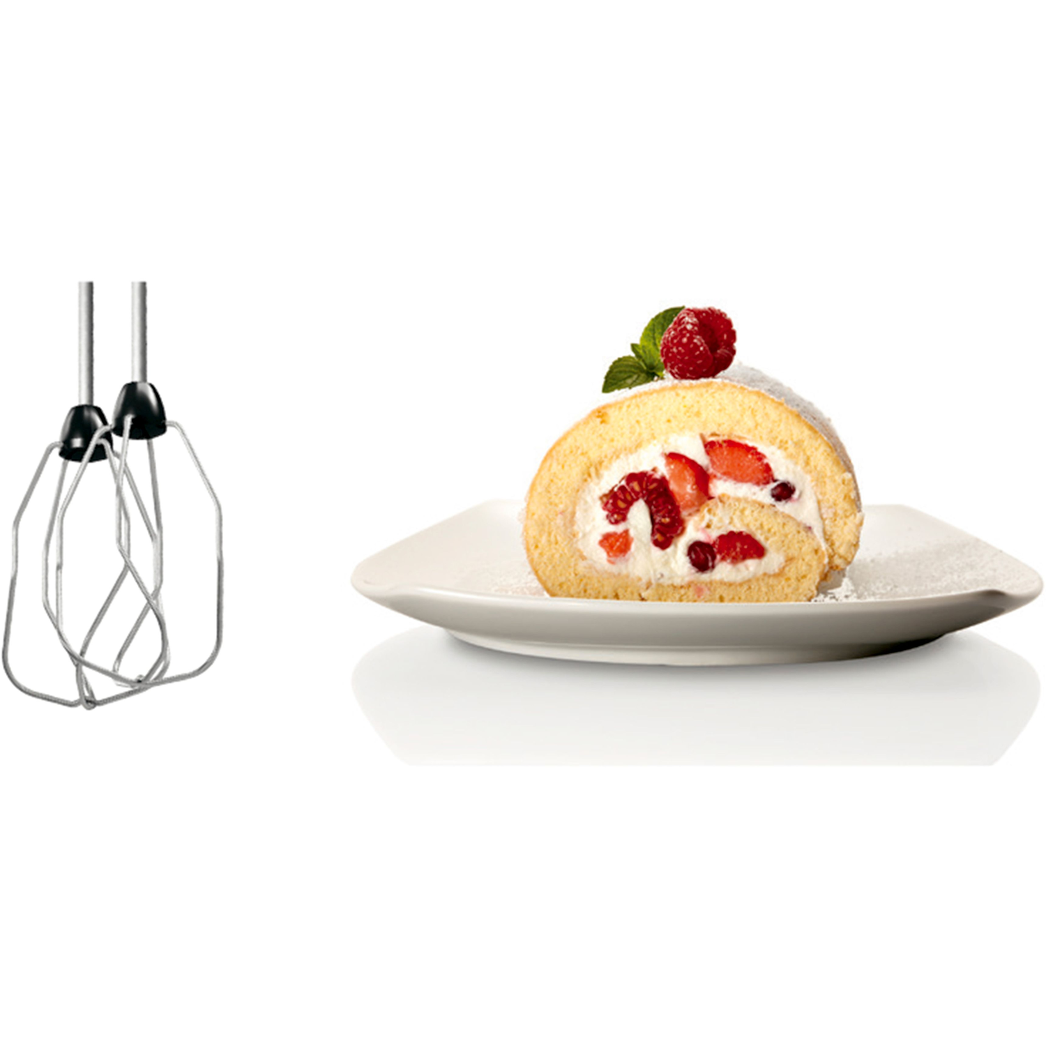 Whisk attachments next to a cake roll with strawberries. White background.