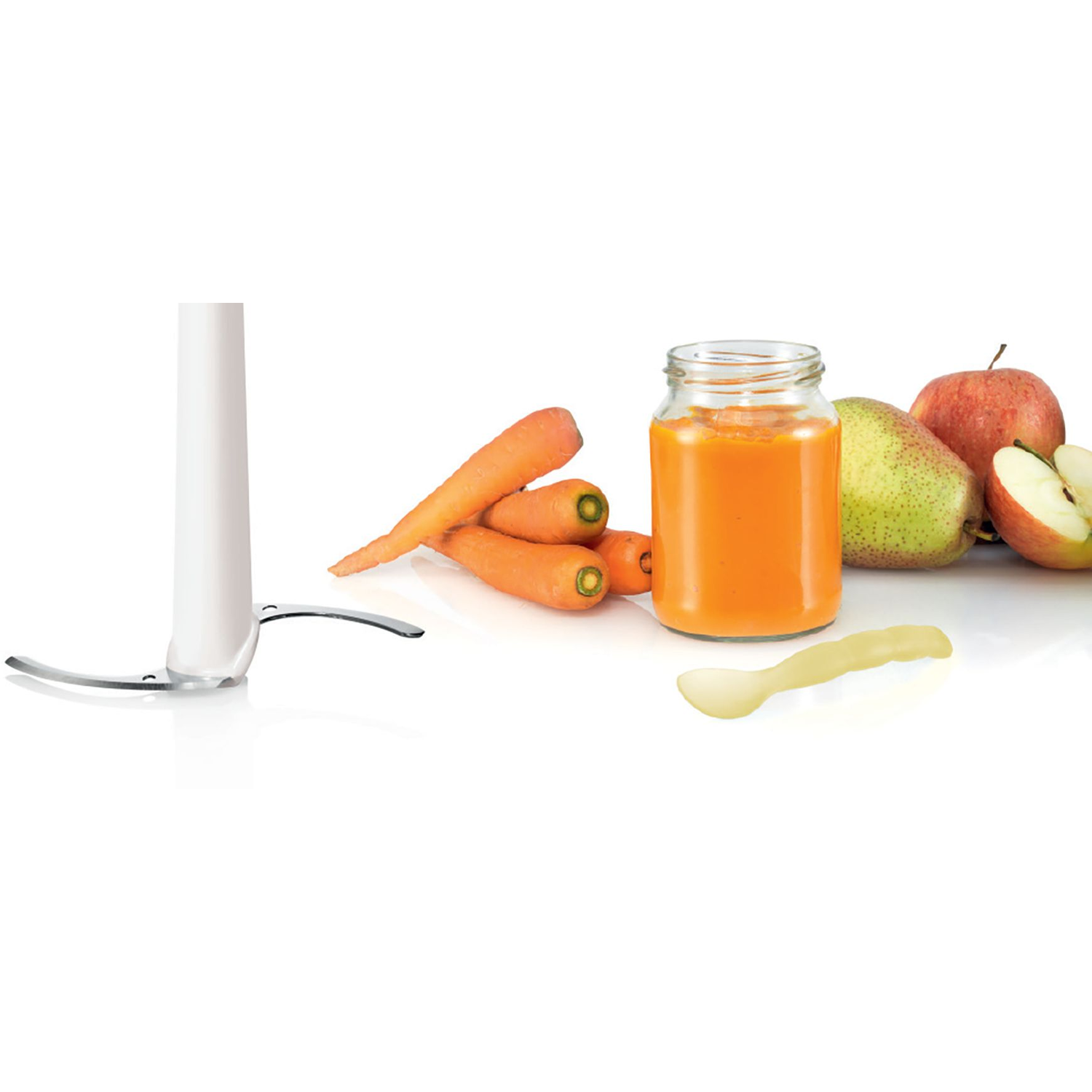 Food processor with carrots, apples, and jar of puree on a white surface.