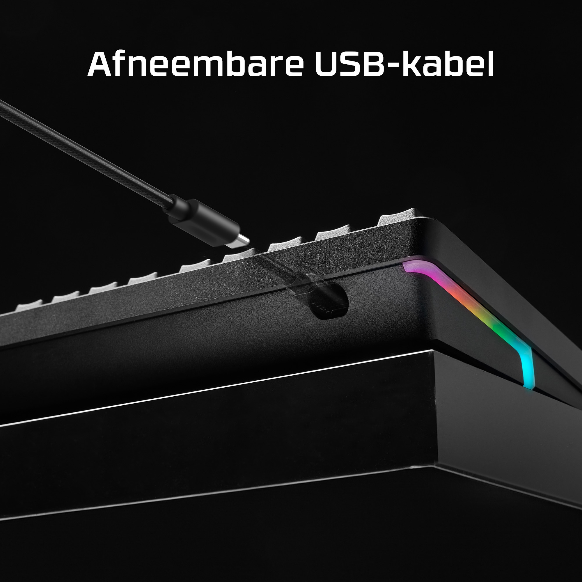 Black keyboard with a USB cable plugged in. The cable has a USB-C connector. The background is dark.