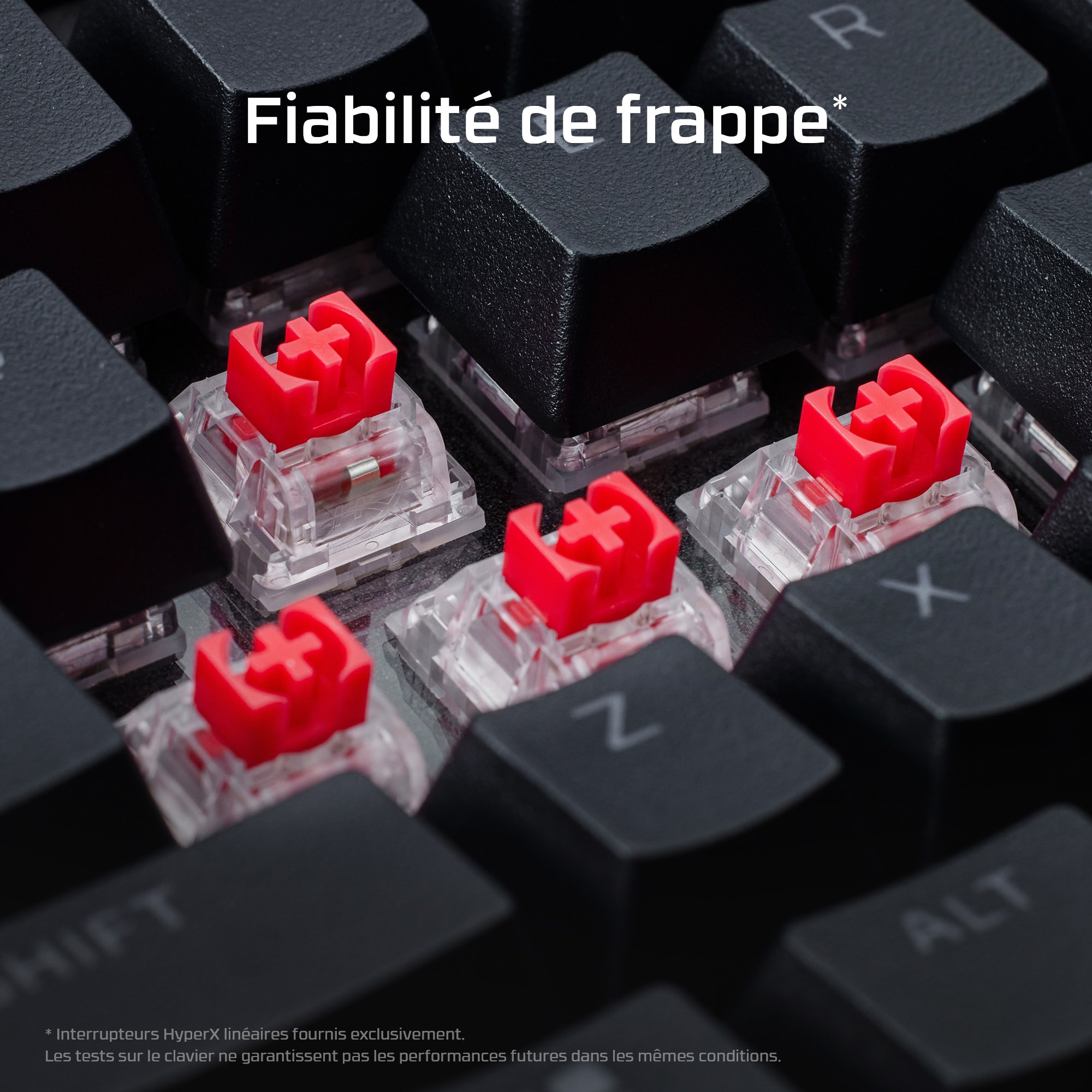 Close-up of red switches on a keyboard. The keys are black and the switches are red.