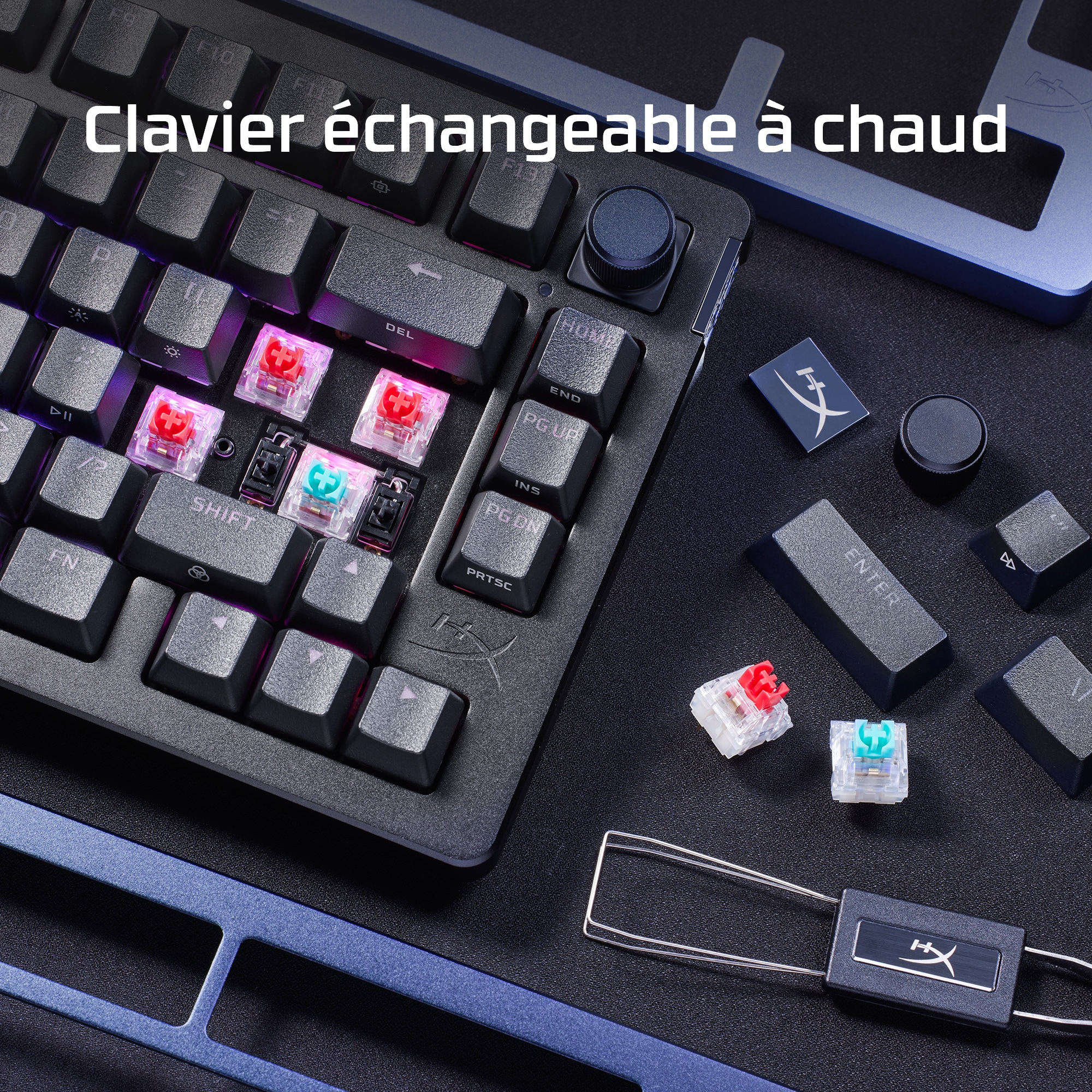 Close-up of a keyboard with hot-swappable keys, with a tool and replacement keys.