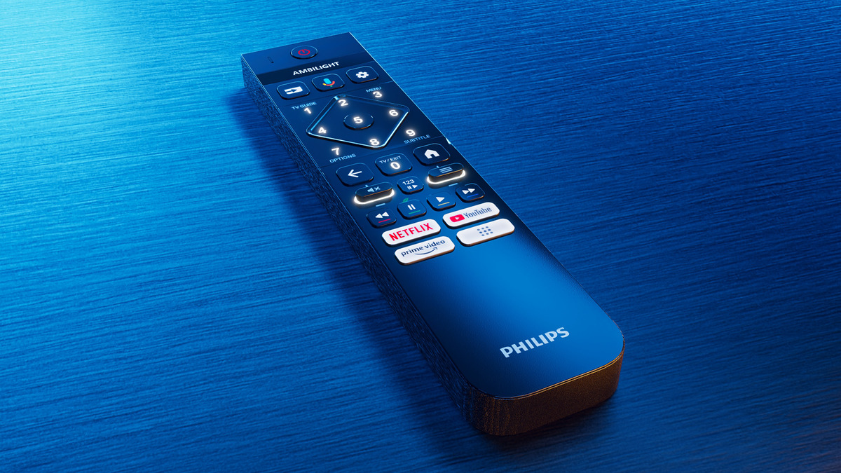 Une télécommande Philips sur une surface en bois bleue. La télécommande possède divers boutons pour les fonctions TV.