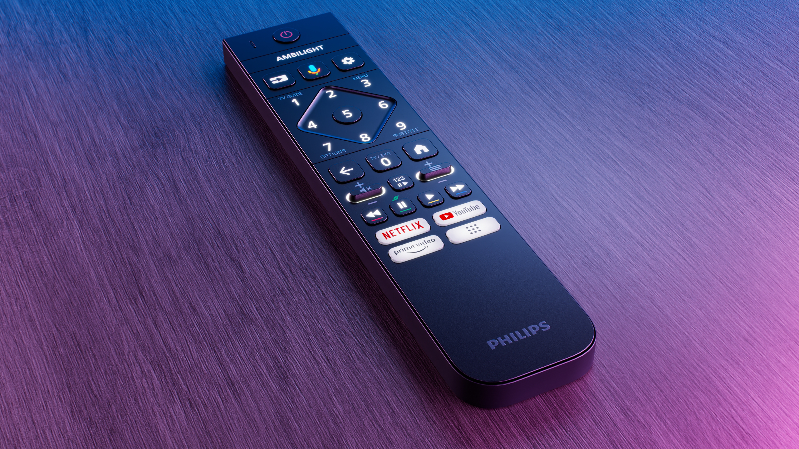 Un telecomando nero con più pulsanti e il logo Philips. È posizionato su una superficie sfumata.