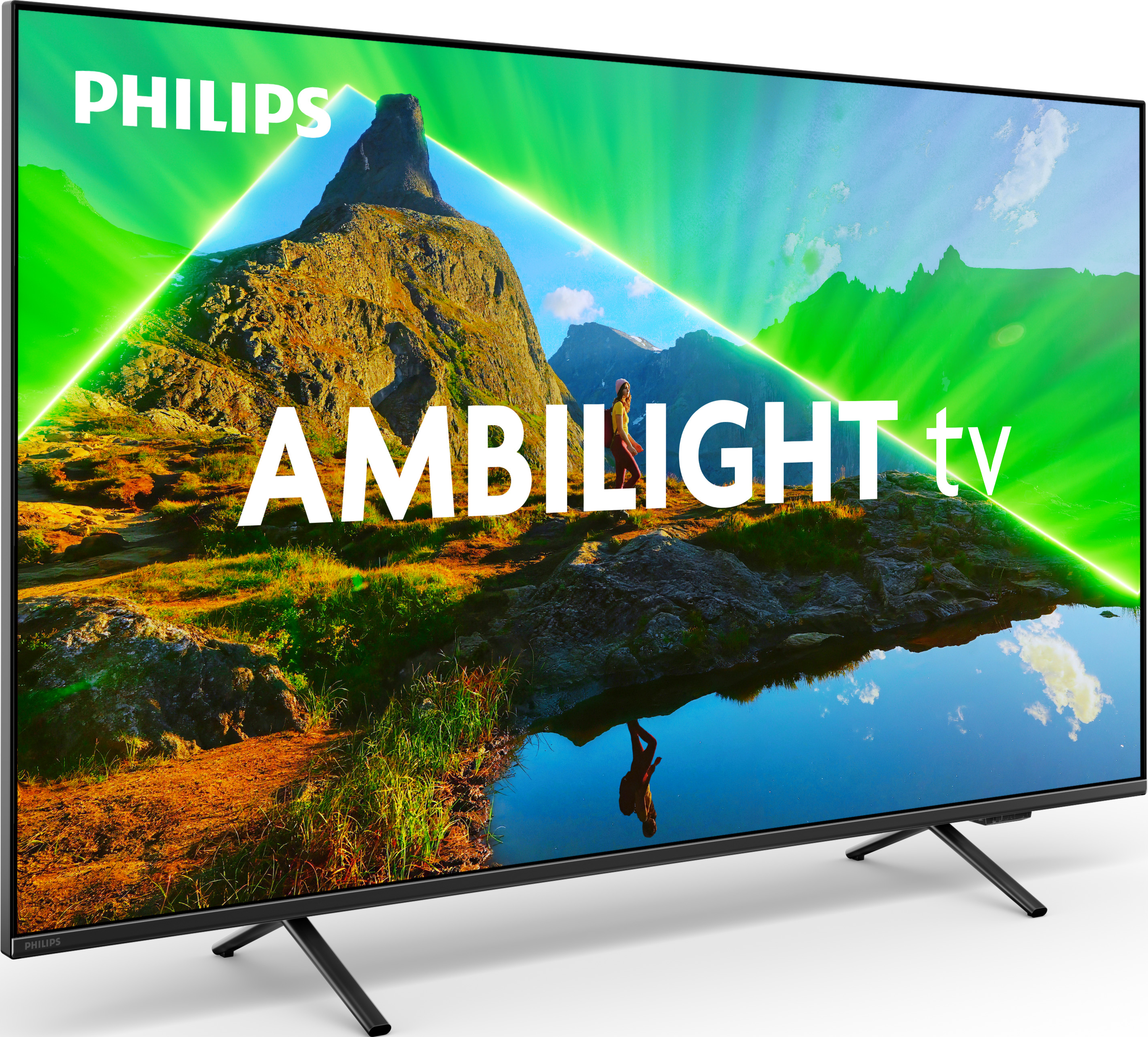 Un televisore Philips Ambilight mostra una scena di montagna con una cornice di luce verde.