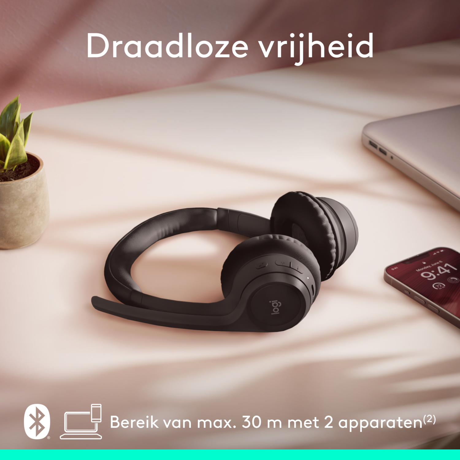 Black wireless headphones and a phone on a desk, the text reads "Wireless freedom".
