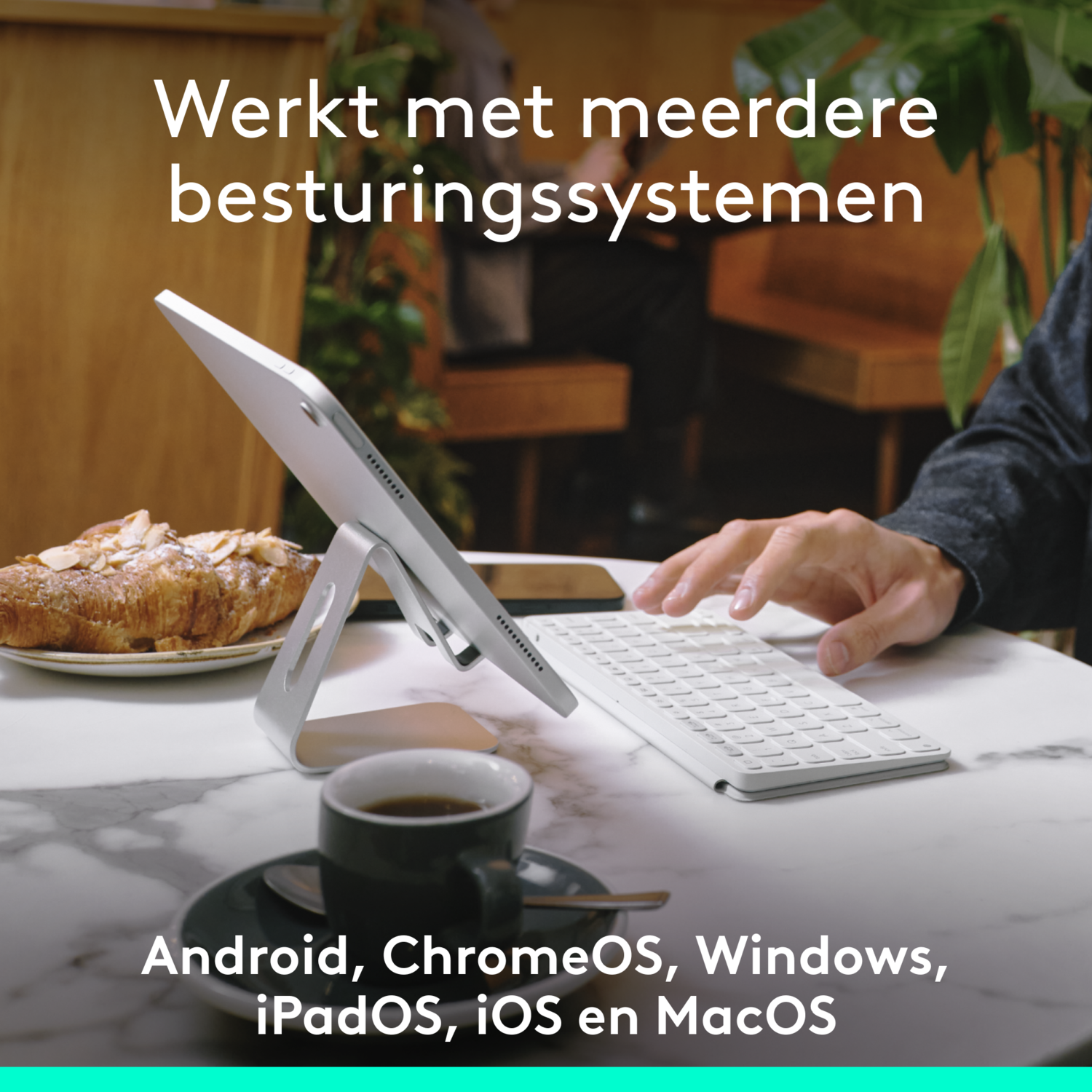A tablet on a stand with a keyboard, coffee, and a croissant. Text says 'Werkt met meerdere...'