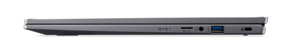 Widok z boku zamkniętego srebrnego laptopa z portami i portem USB.